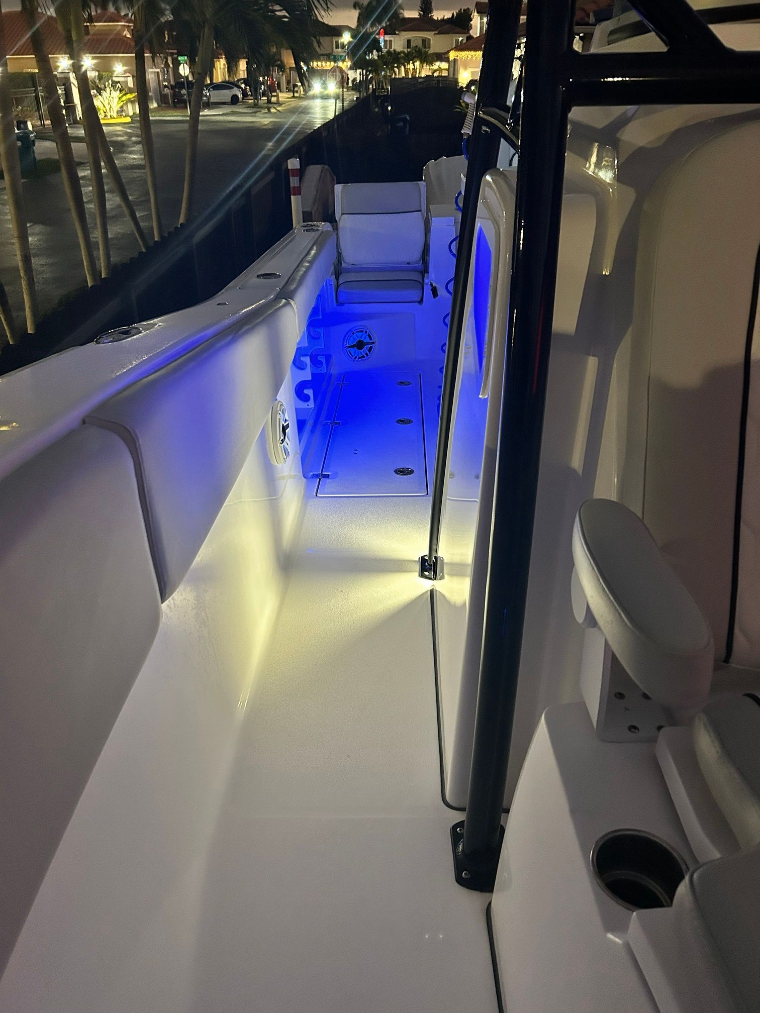 The image shows the deck of a Sea Fox 288 Commander boat at night with blue lighting.