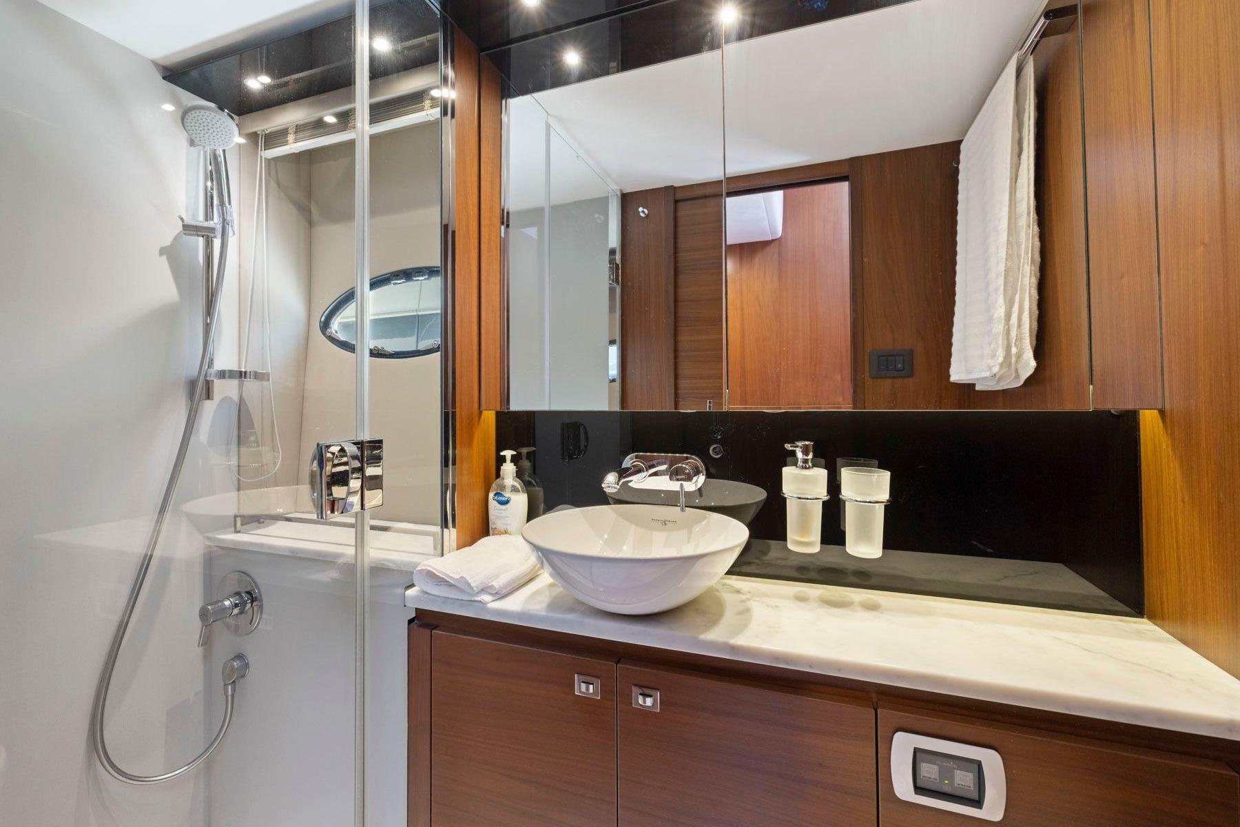 Luxurious bathroom in 2015 Princess 60 Flybridge Motor Yacht with modern fixtures and elegant design.