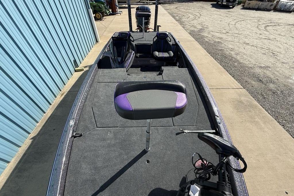 2026 Skeeter ZXE21 fishing boat with purple accents, docked beside a blue building.
