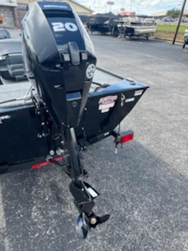 2025 Tracker Panfish 17 boat with a 20 HP outboard motor, parked on asphalt.