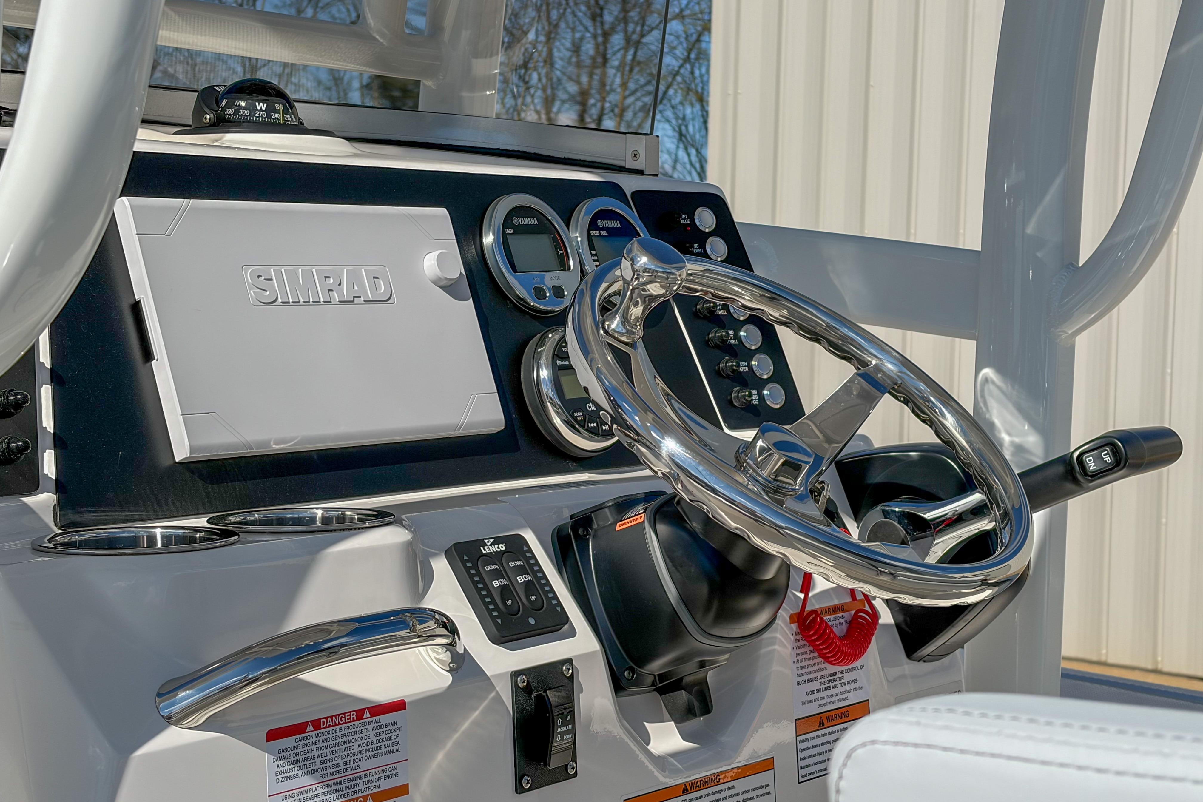 2025 Robalo 226 Cayman boat dashboard with Simrad display and steering wheel.
