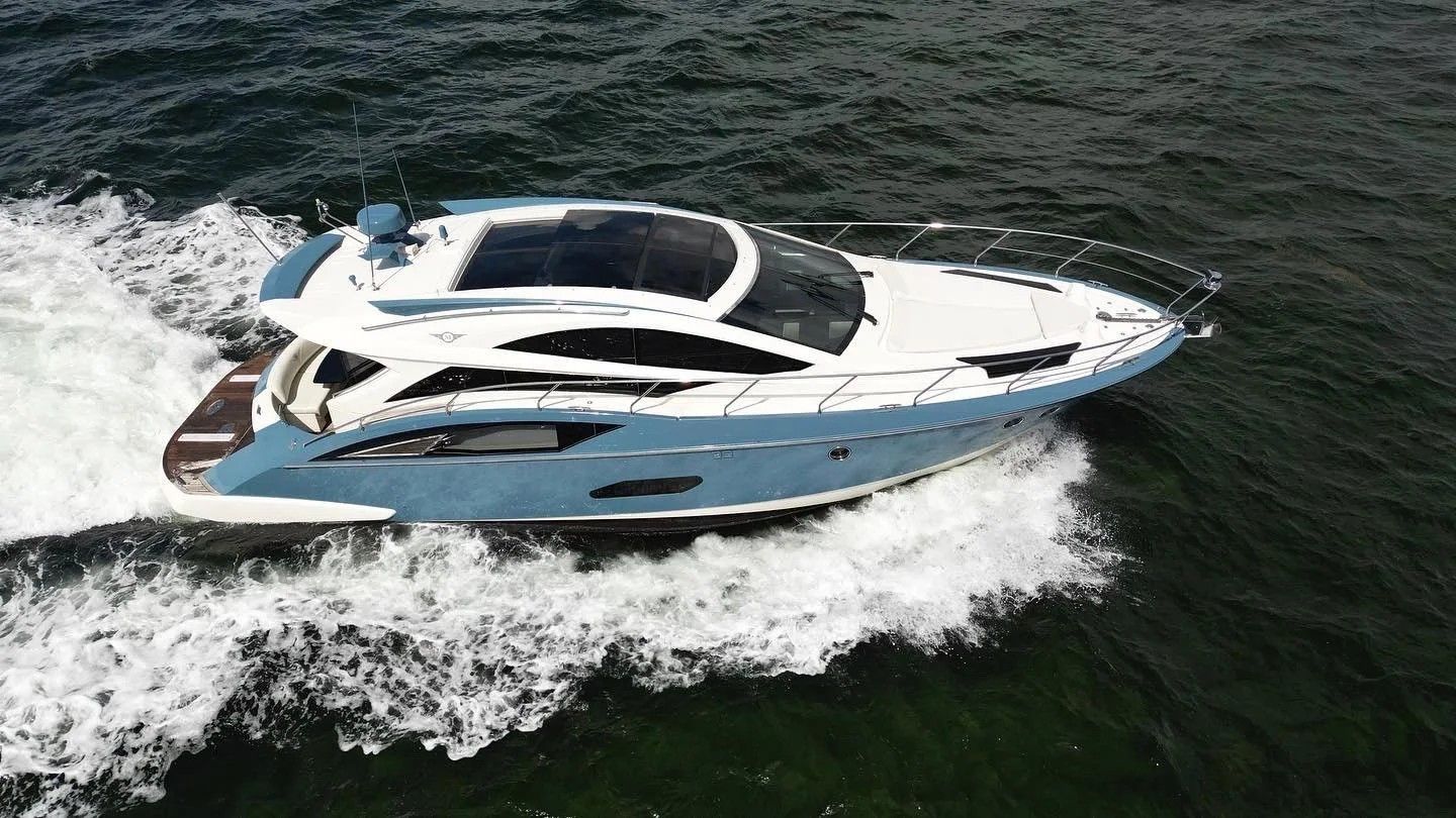 A 2010 Marquis Sport Coupe speeds across the water, featuring sleek design and blue paint.