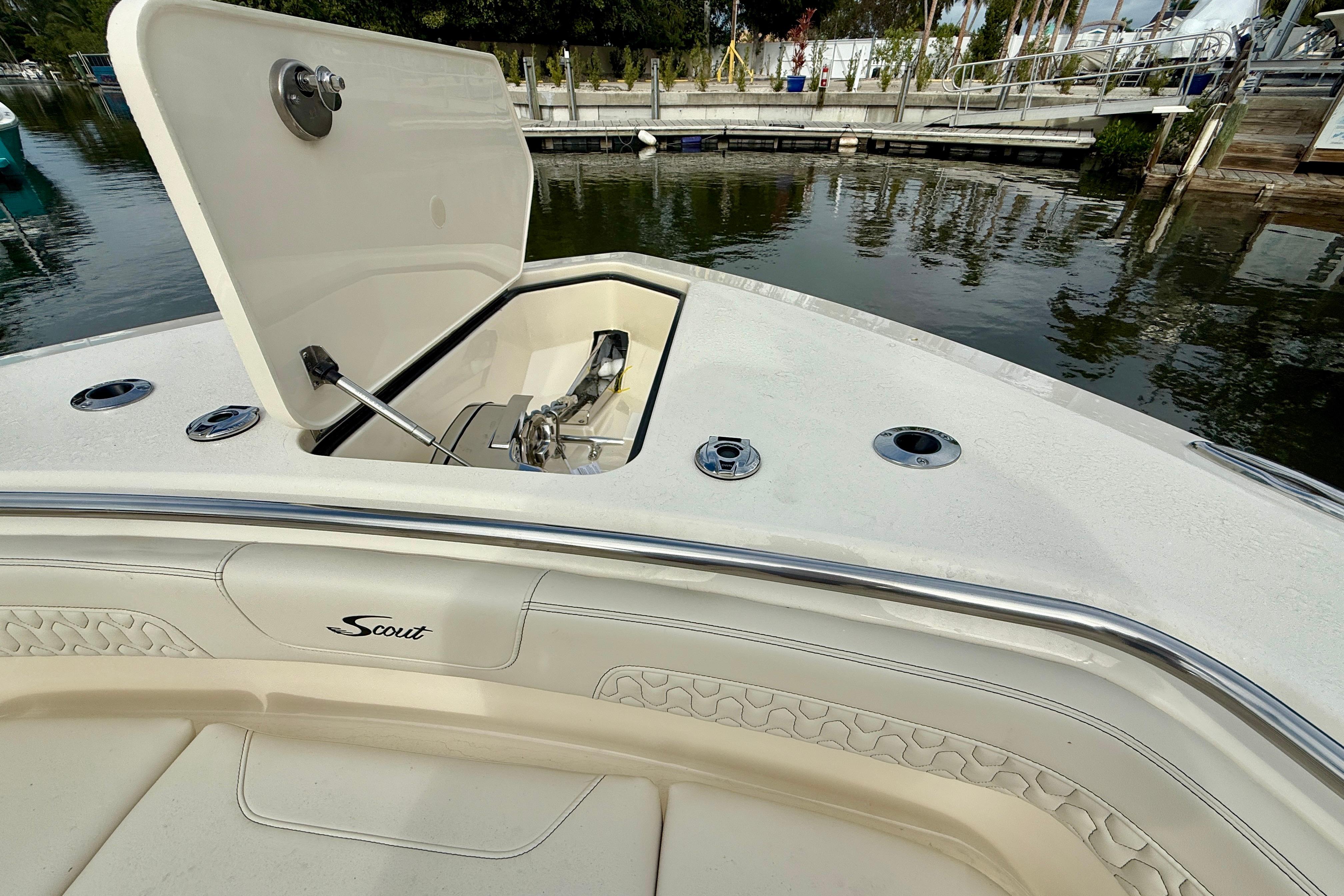 2026 Scout 288 LXF boat with open anchor compartment at dockside.