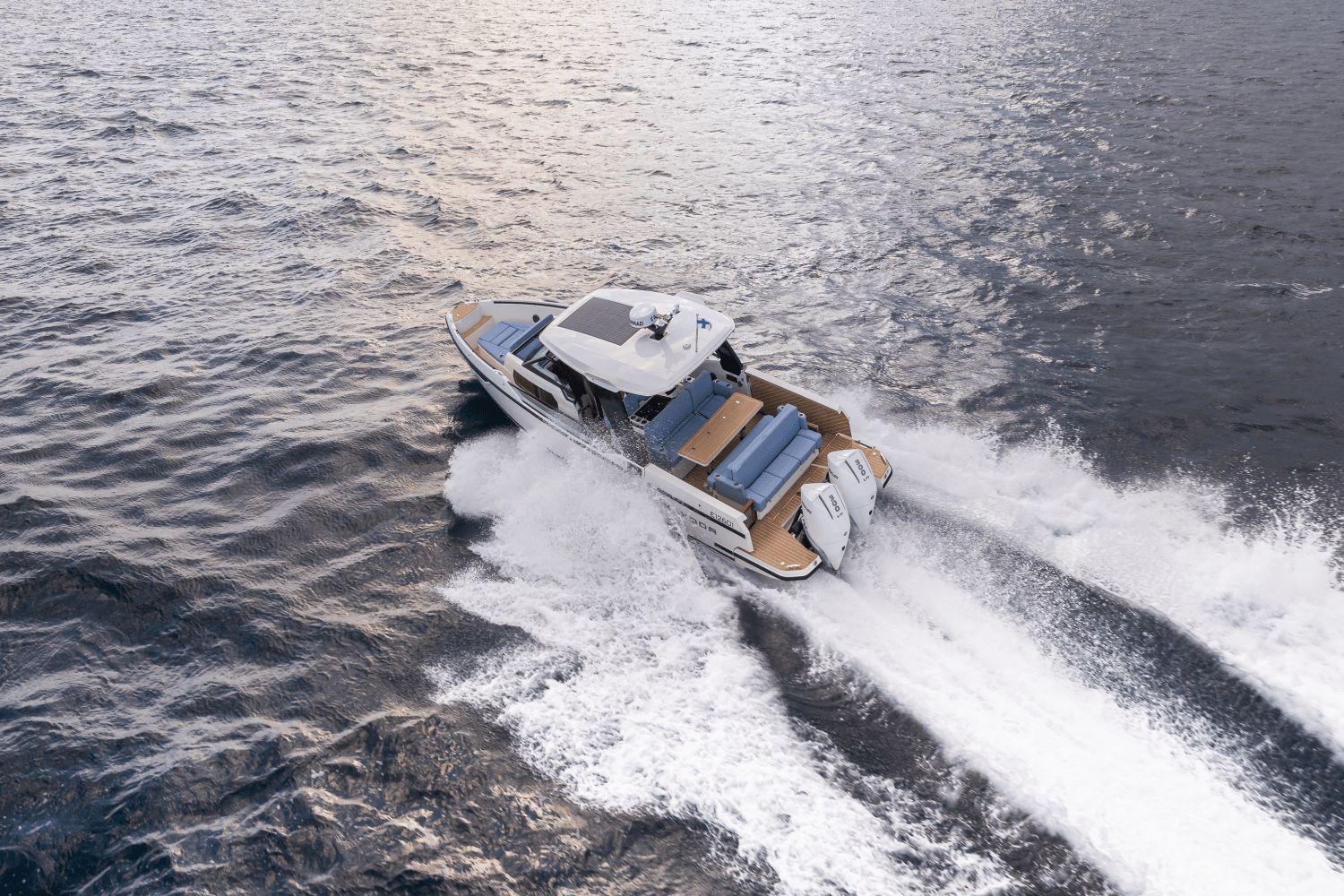 A 2027 Saxdor SX320 GTO speeds across the water, leaving a white wake behind.
