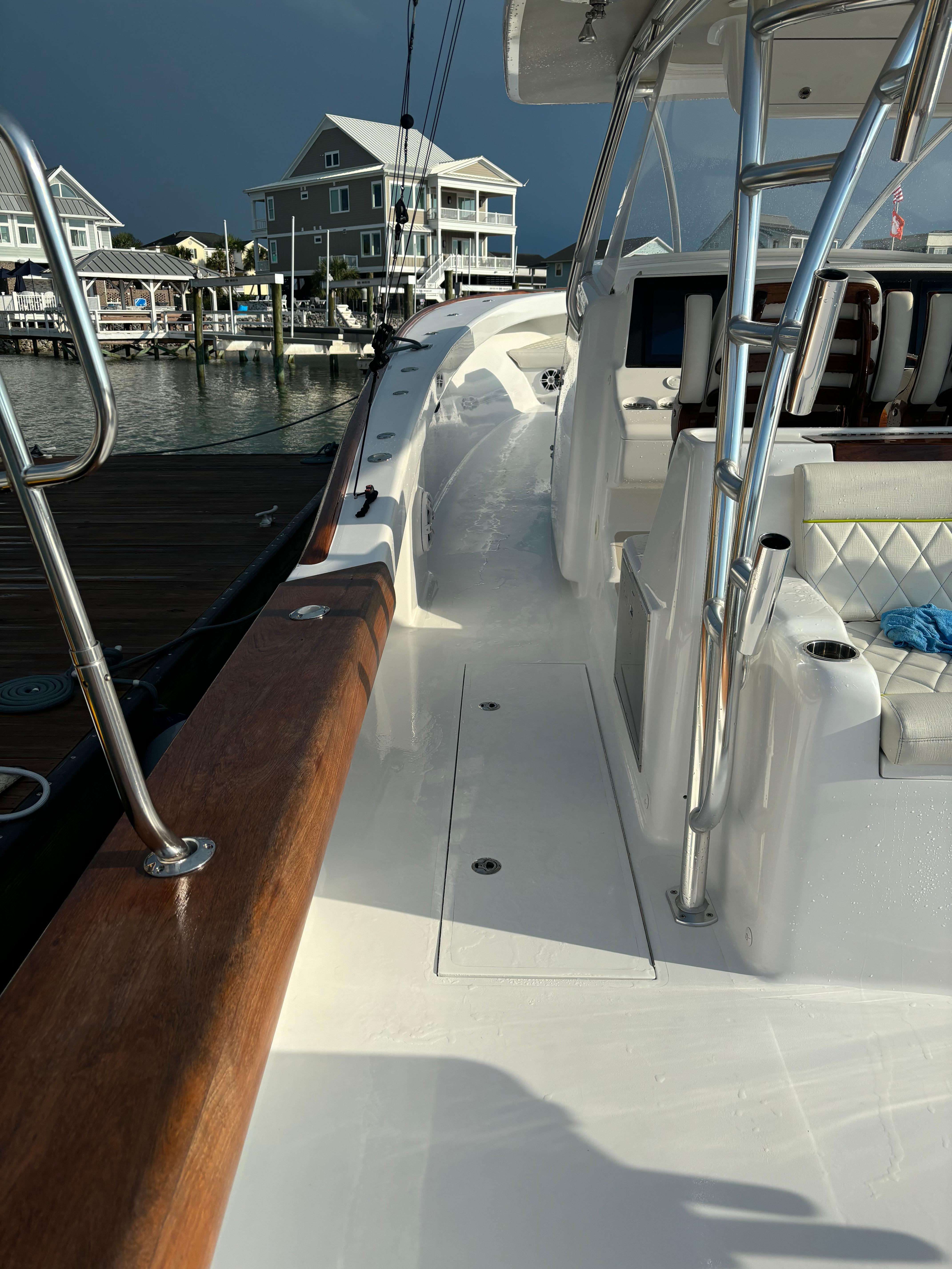 2025 Mystique Boatworks M48 Custom Carolina docked, showcasing sleek design and modern features.