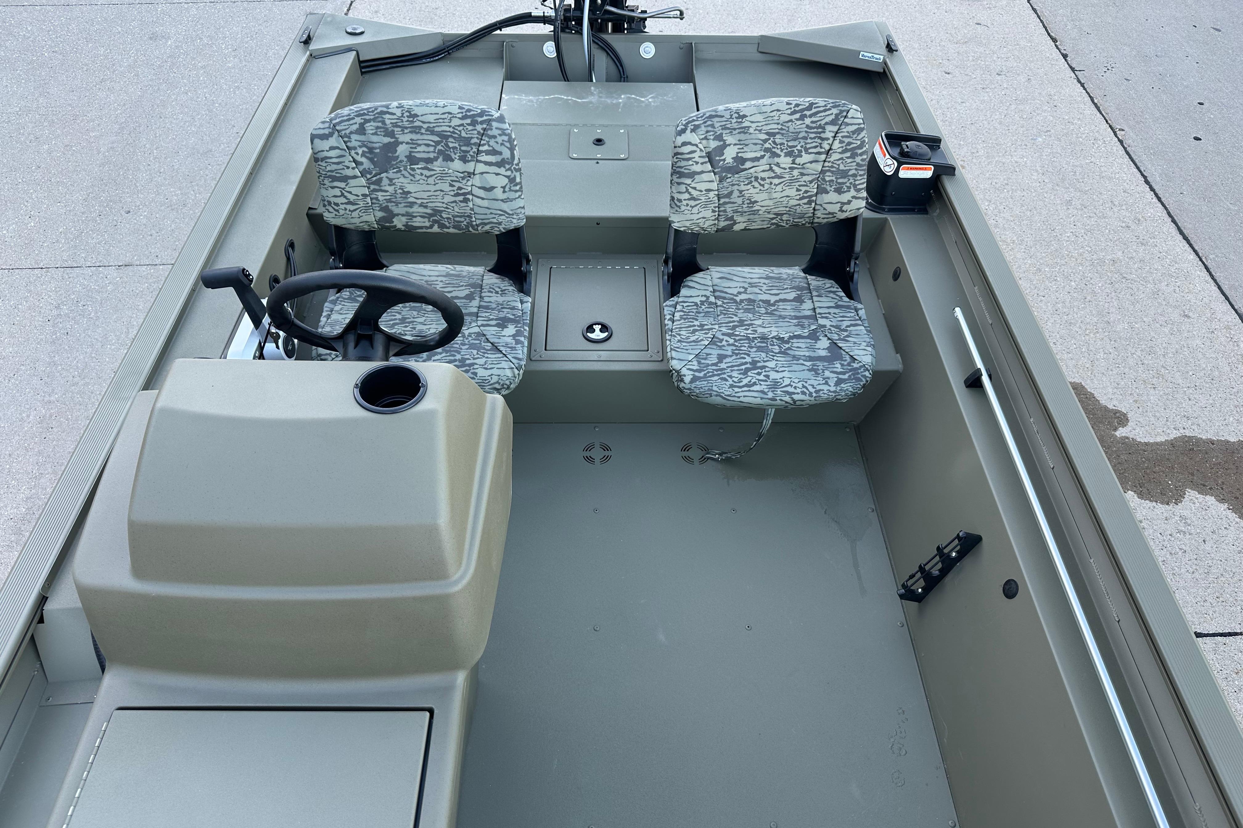 2026 Tracker Grizzly 1754 SC boat interior with camo seats and steering console.