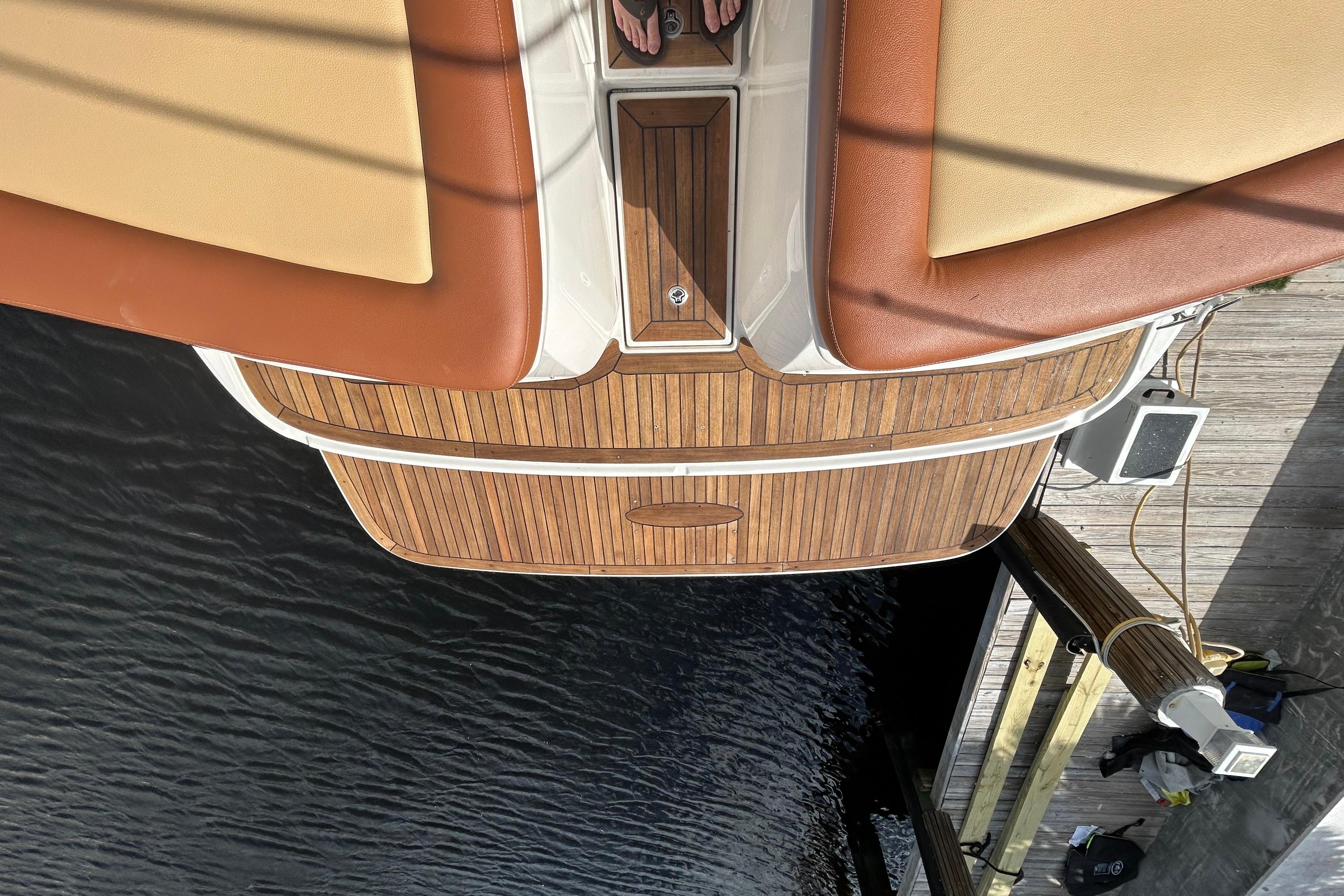 2014 Sea Ray 370 Venture boat with teak deck and cushioned seating at dock.