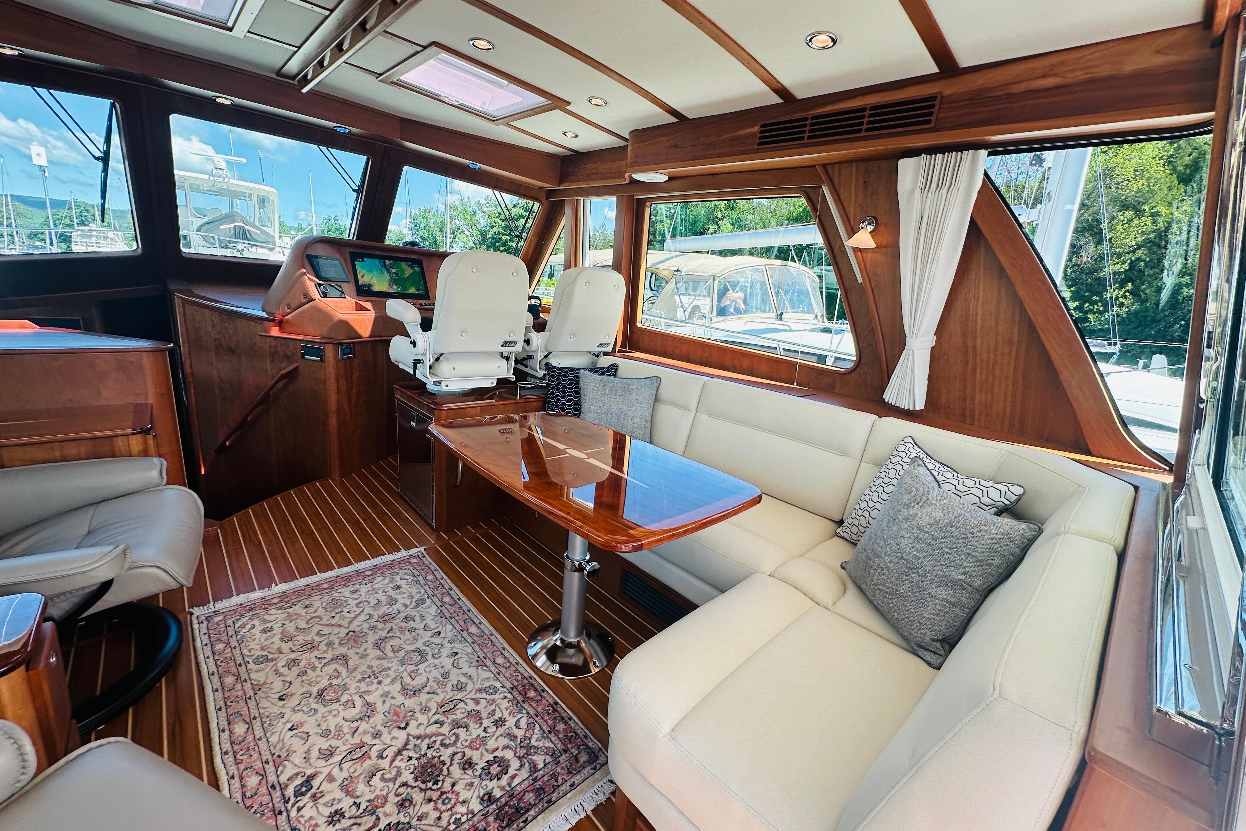 Luxurious interior of 2025 Sabre 48 Salon Express yacht with elegant seating and wood finishes.
