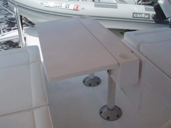 Great Harbour N40 2025 yacht interior with white seating and foldable table.