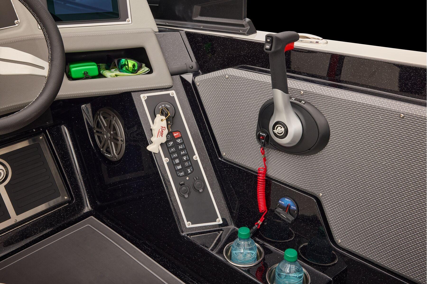 Manufacturer Provided Image: 2026 Ranger 620xFS Pro boat dashboard with controls, steering wheel, and storage compartments.