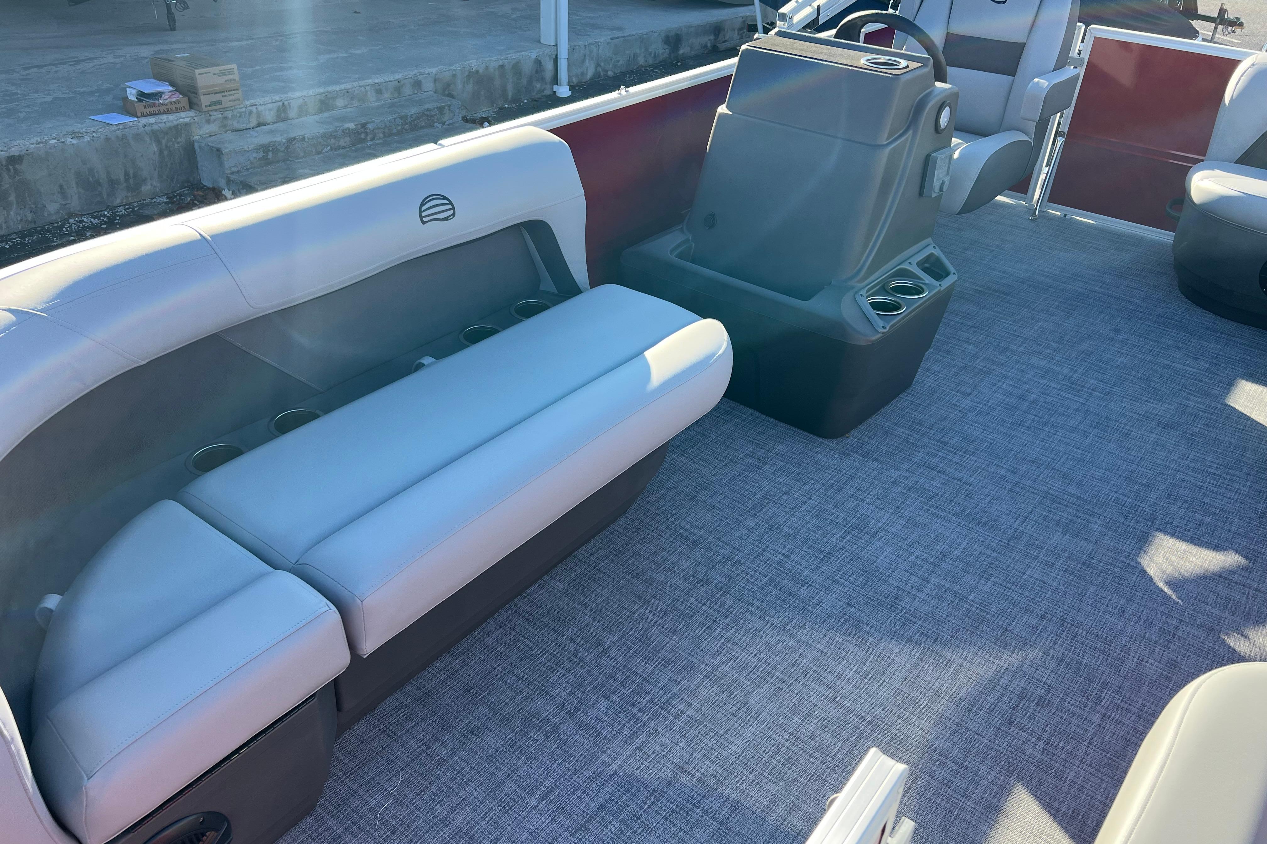 2026 Sun Tracker Party Barge 16 DLX interior with seating and helm station.