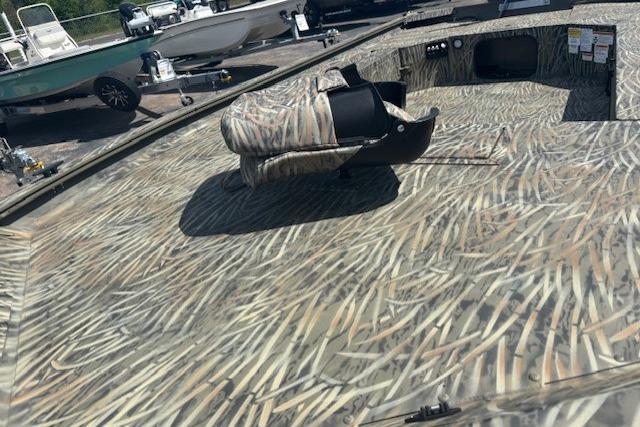 2026 Tracker Grizzly 1654 T Sportsman boat with camouflage pattern and seating.