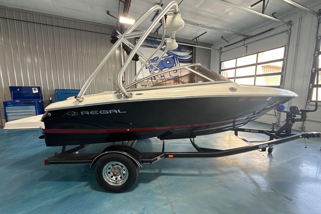 2012 Regal 1900 Bowrider boat on trailer in indoor garage setting.