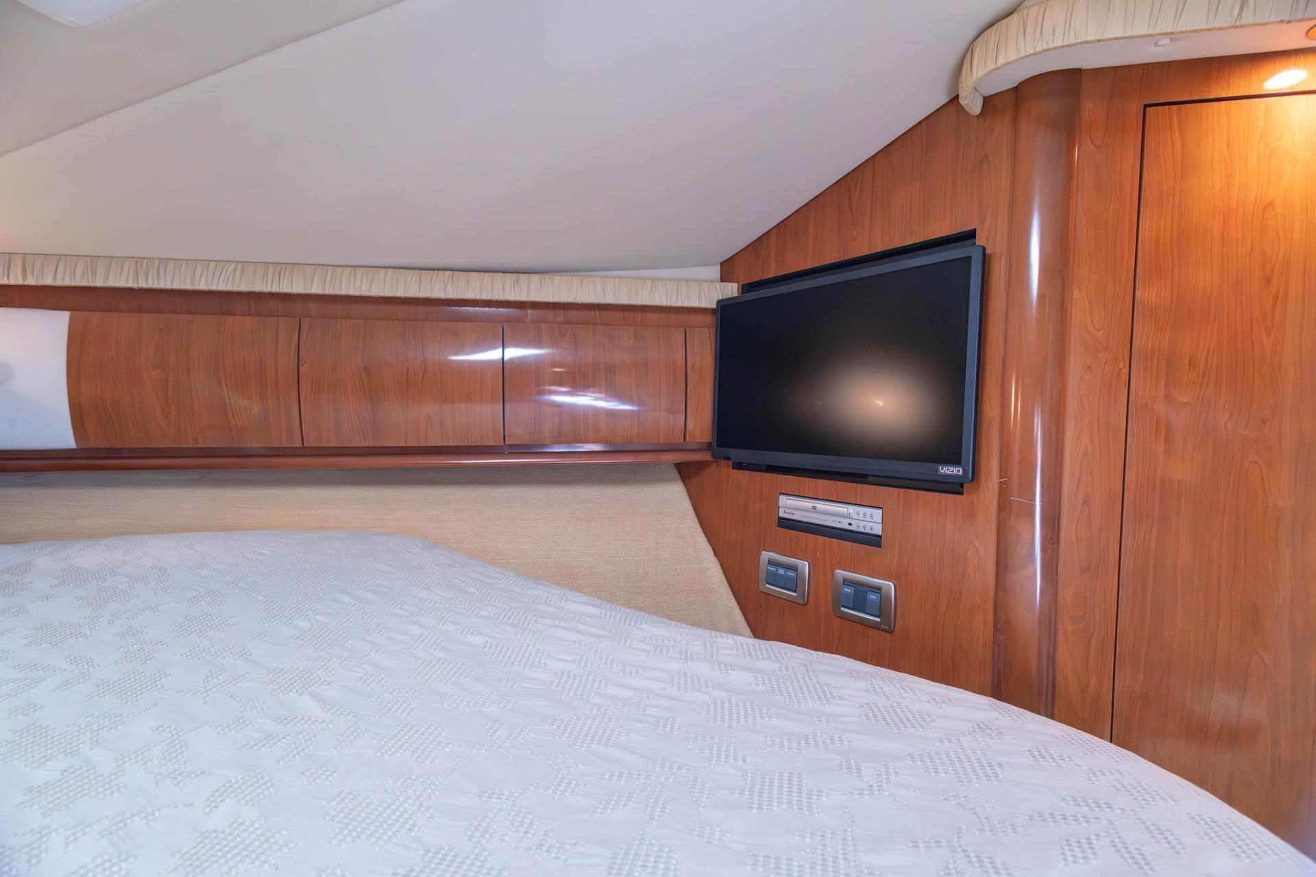Luxurious cabin interior of 2005 Sea Ray 420 Sundancer with TV and wood paneling.