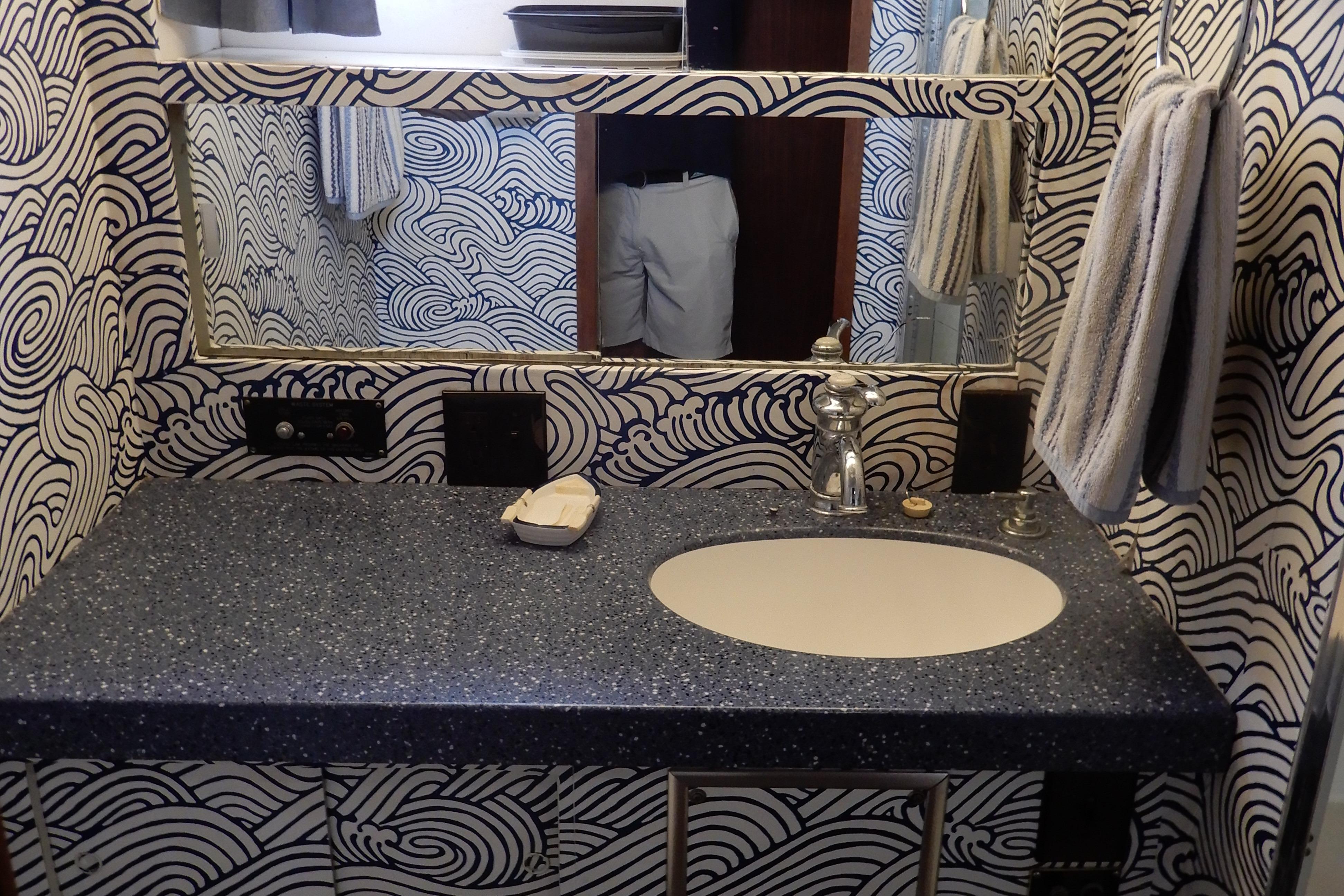 Bathroom interior of 1979 Hatteras 53 Motor Yacht with wave-patterned wallpaper.