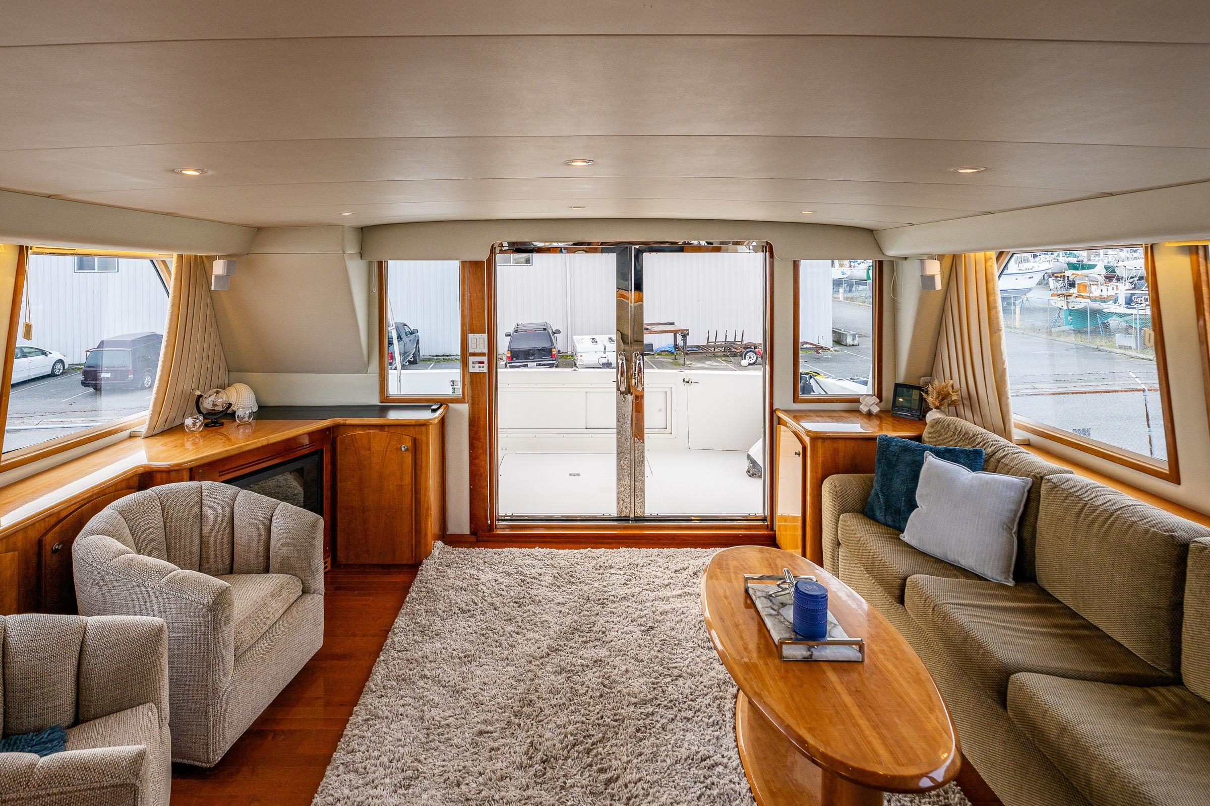 Luxurious 2001 Navigator Pilothouse yacht interior with plush seating and elegant wood finishes.