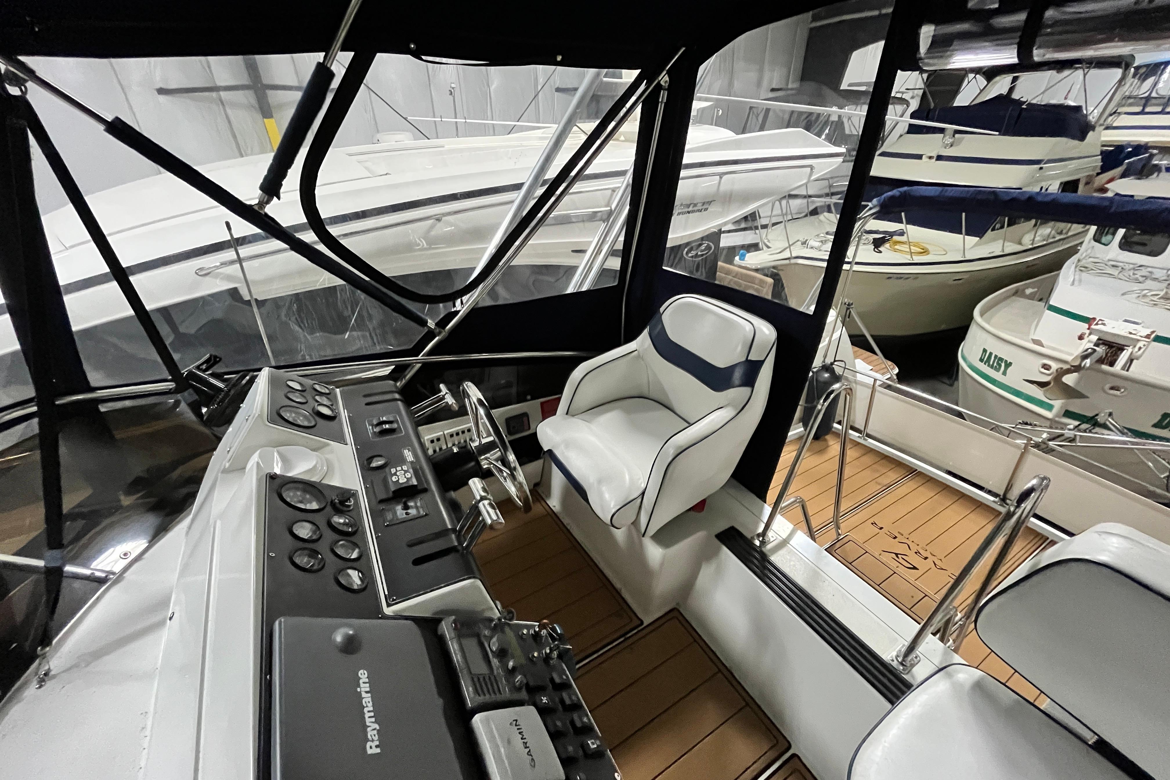 1995 Carver 325 Aft Cabin Motor Yacht helm with controls and seating in marina.
