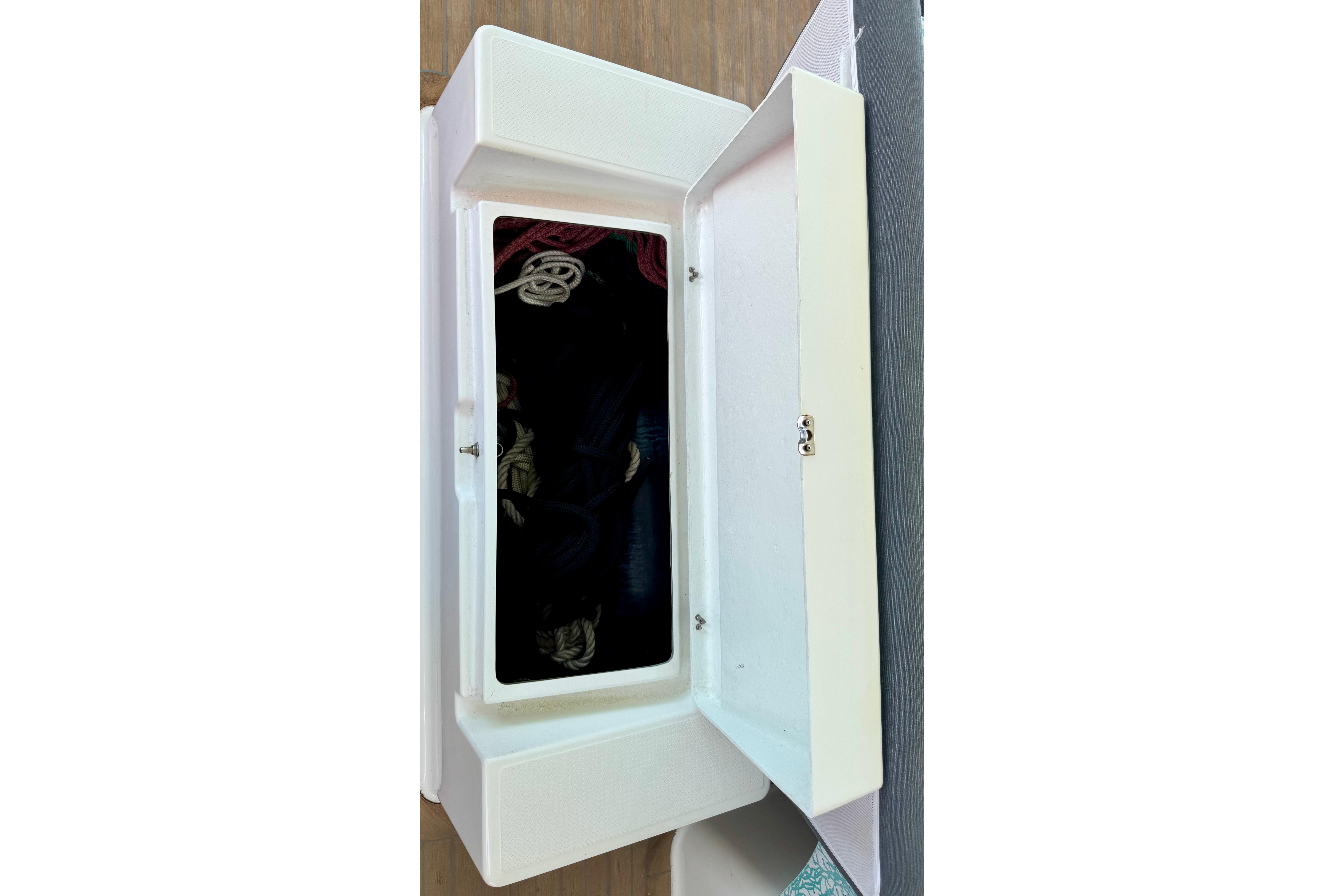 Open storage compartment on 2020 Fountaine Pajot Saona 47 yacht, showcasing interior space.