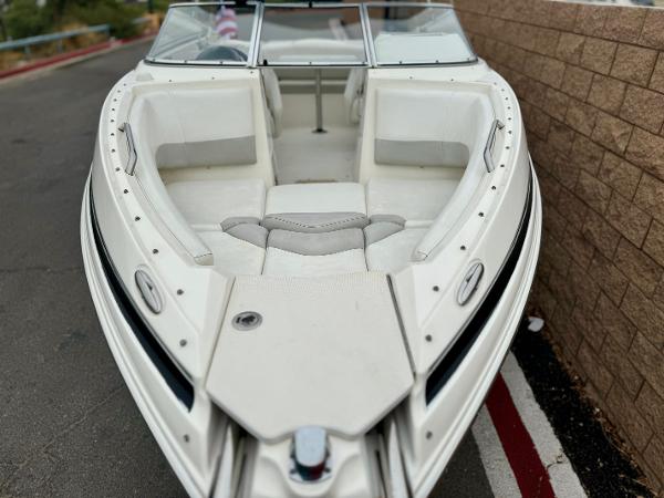 2006 Larson LXi 248 boat with white seating and sleek design.