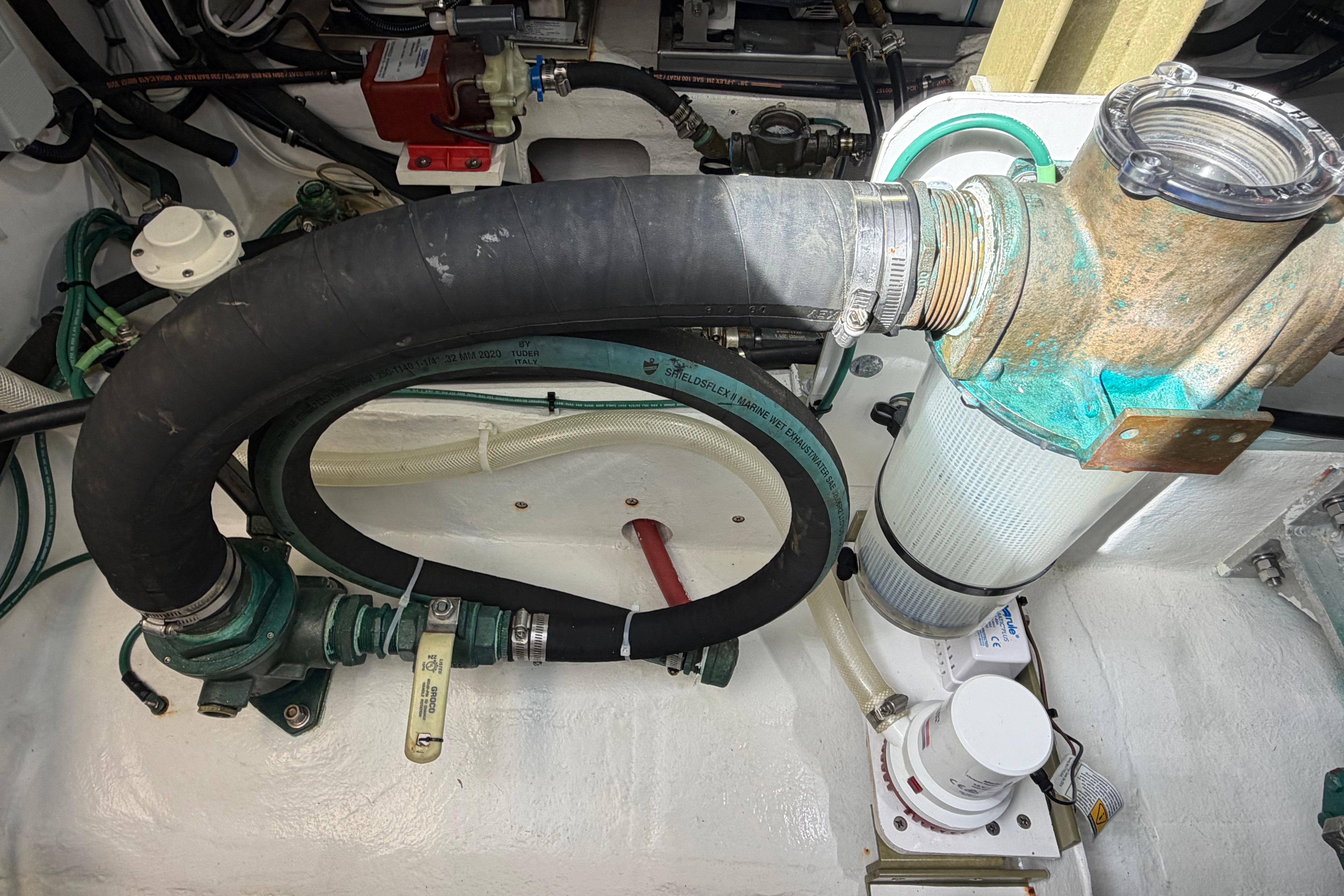 Engine room of 2018 H&H Marine Osmond Beal boat with hoses and filters.