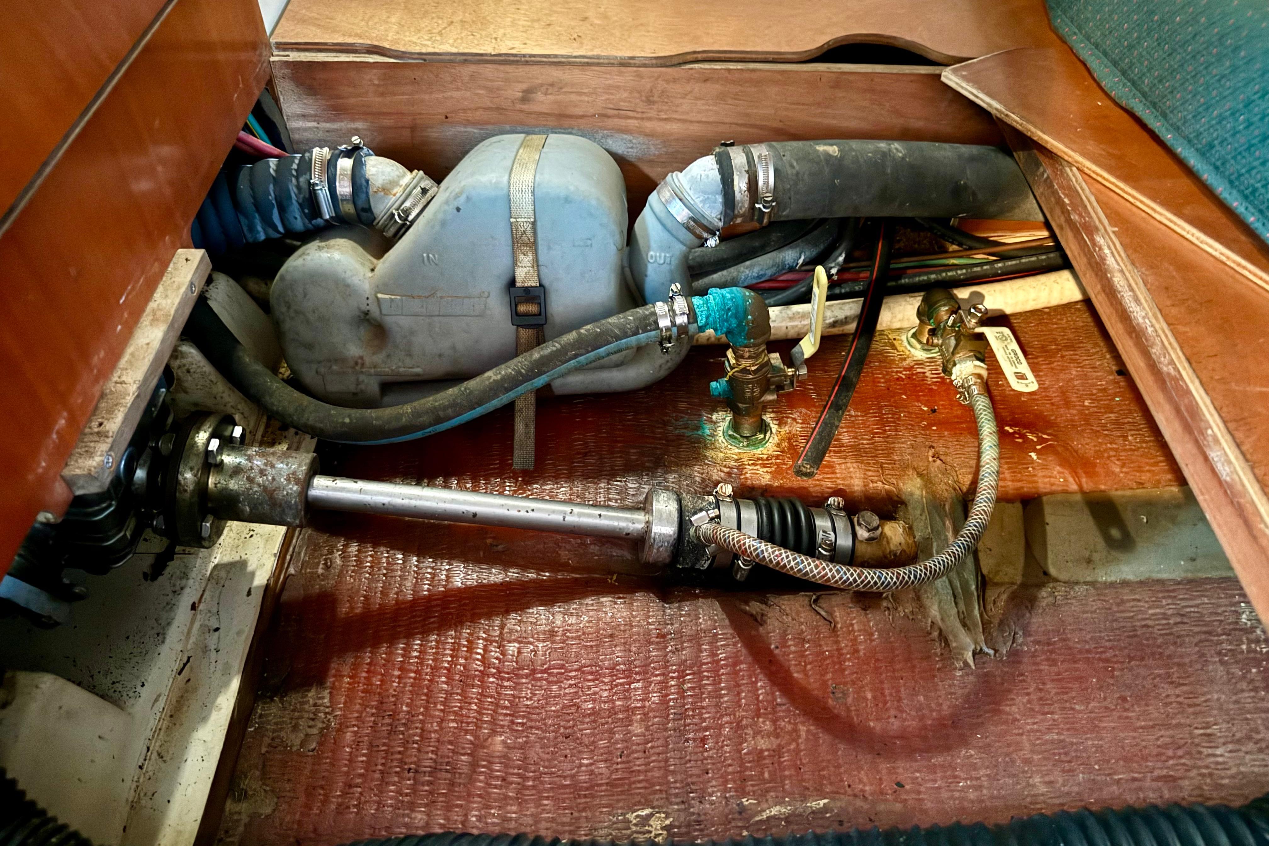 Engine compartment of a 2002 Beneteau Oceanis Clipper 311 sailboat, showing mechanical components.