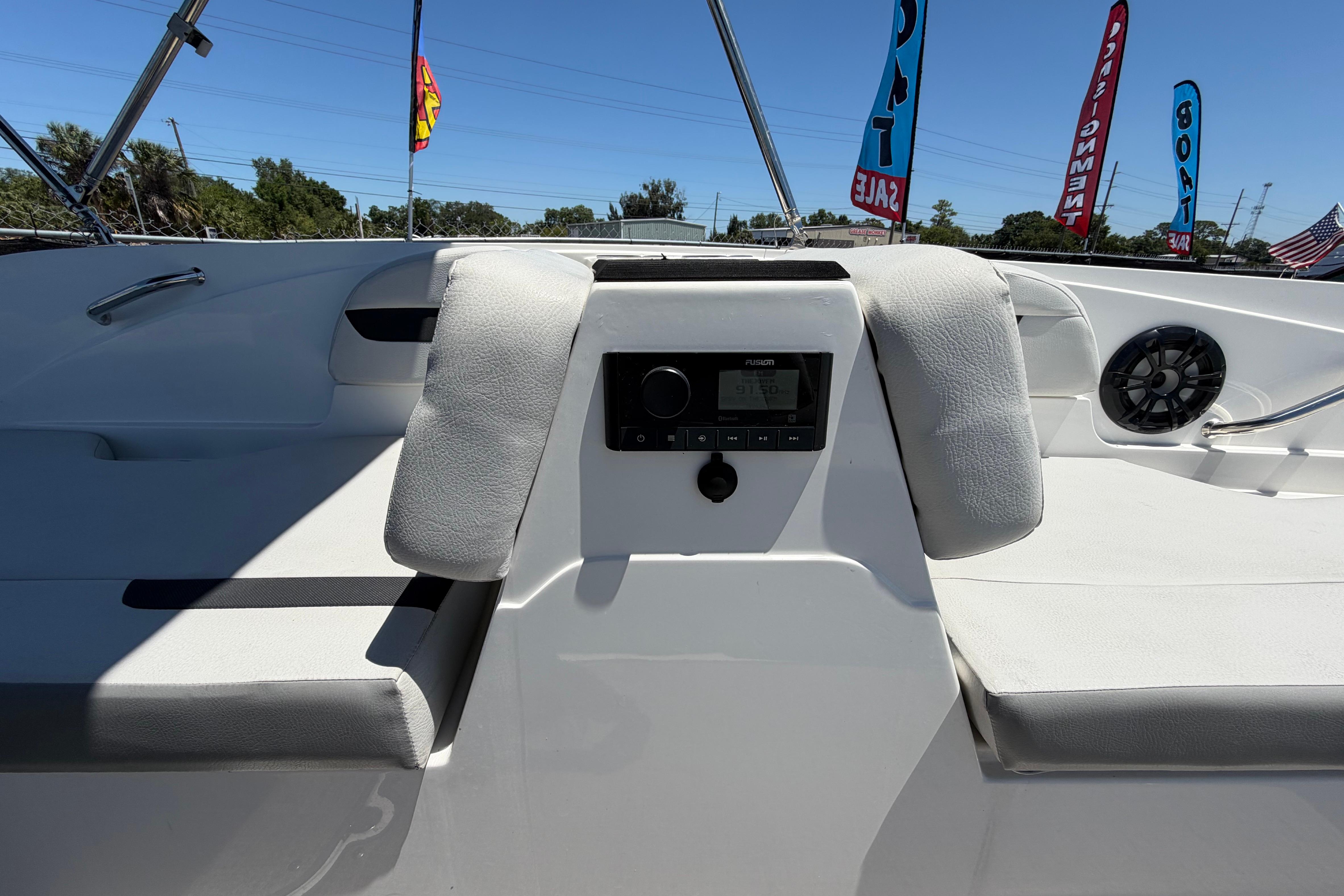 Interior view of 2022 Hurricane SunDeck Sport 185 OB boat with seating and audio system.