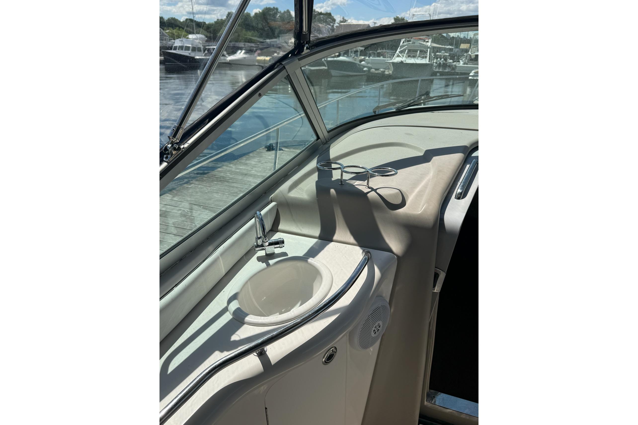 2006 Sea Ray 300 Sundancer boat interior with sink and cup holders.