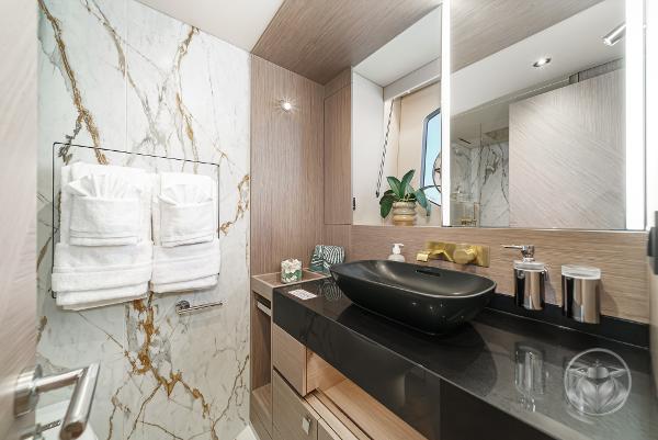Luxurious bathroom in 2025 Sunseeker Manhattan 68 yacht with marble accents and modern fixtures.
