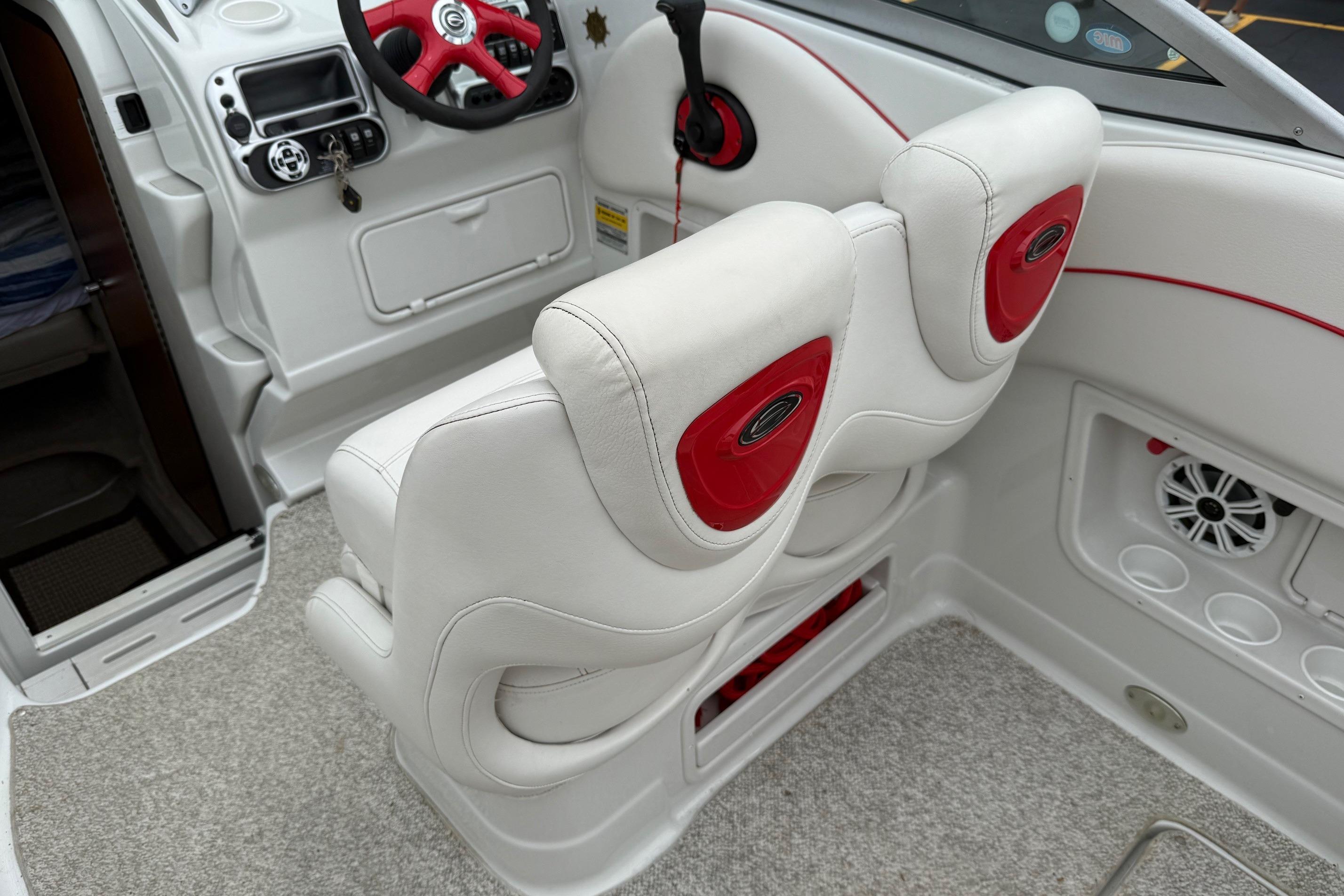 Interior of a 2005 Crownline 250 CR boat with white and red seating.