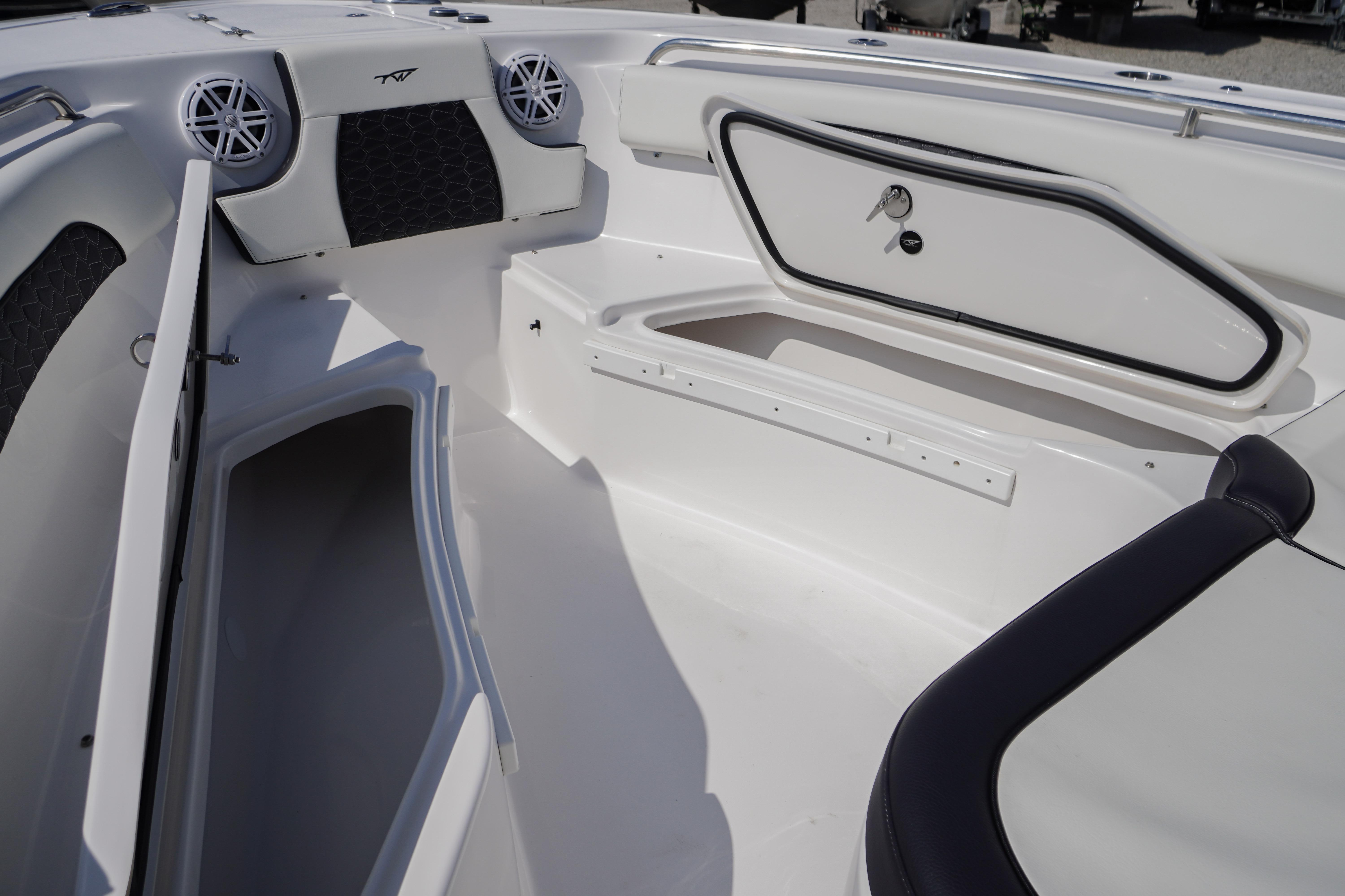 Interior of 2025 Tidewater 232 SS boat, featuring storage compartments and sleek design.