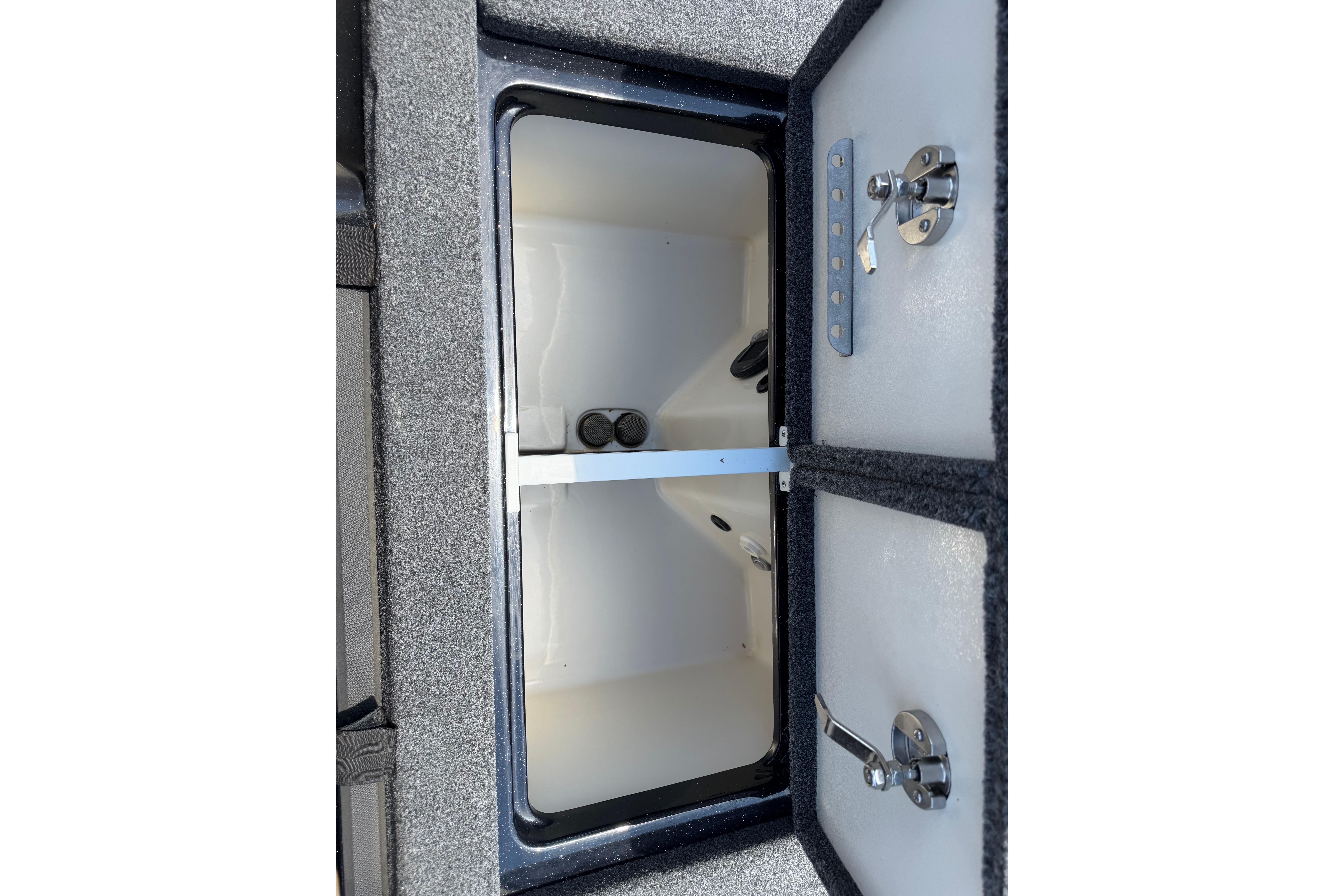 2023 Ranger Z520R storage compartment with dual latches and carpeted interior.
