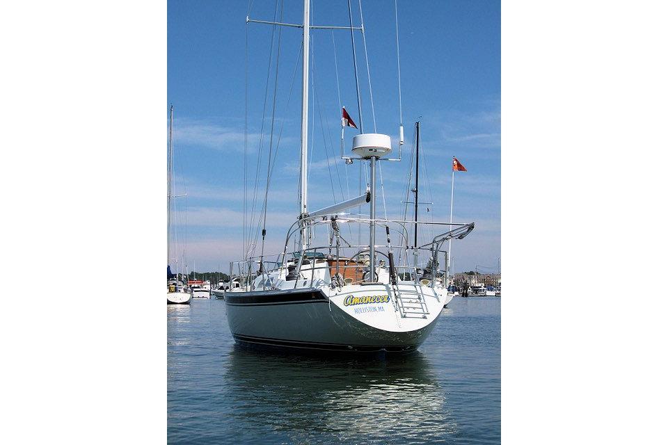 1987 Ericson 38-200 sailboat docked in a marina under clear blue skies.