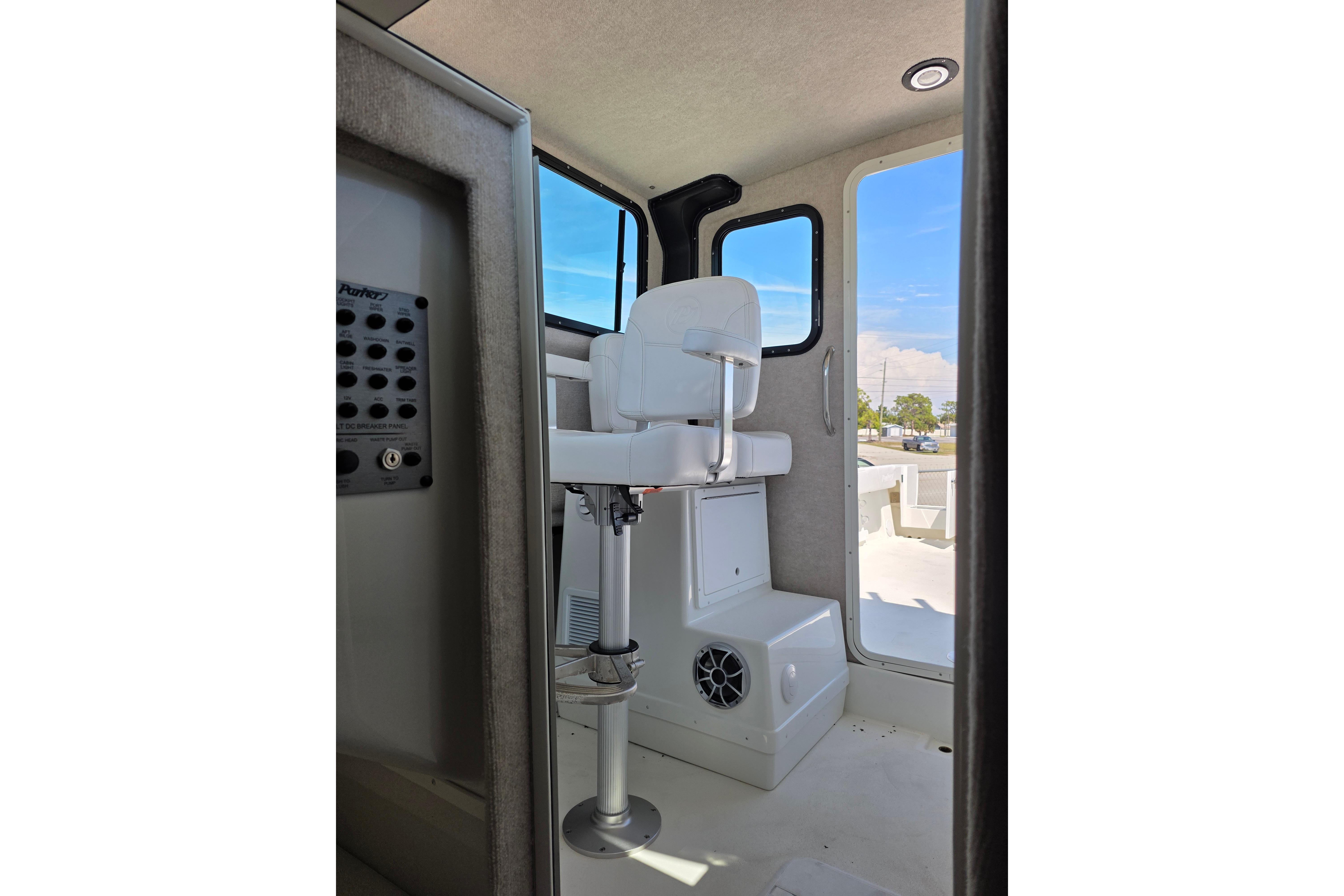 Interior view of 2026 Parker 287 Explorer boat with captain's chair and control panel.