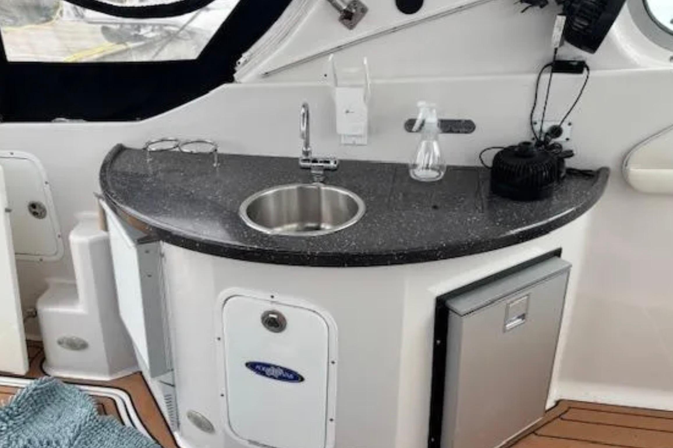 2007 Four Winns 378 Vista boat interior with kitchenette, sink, and countertop.