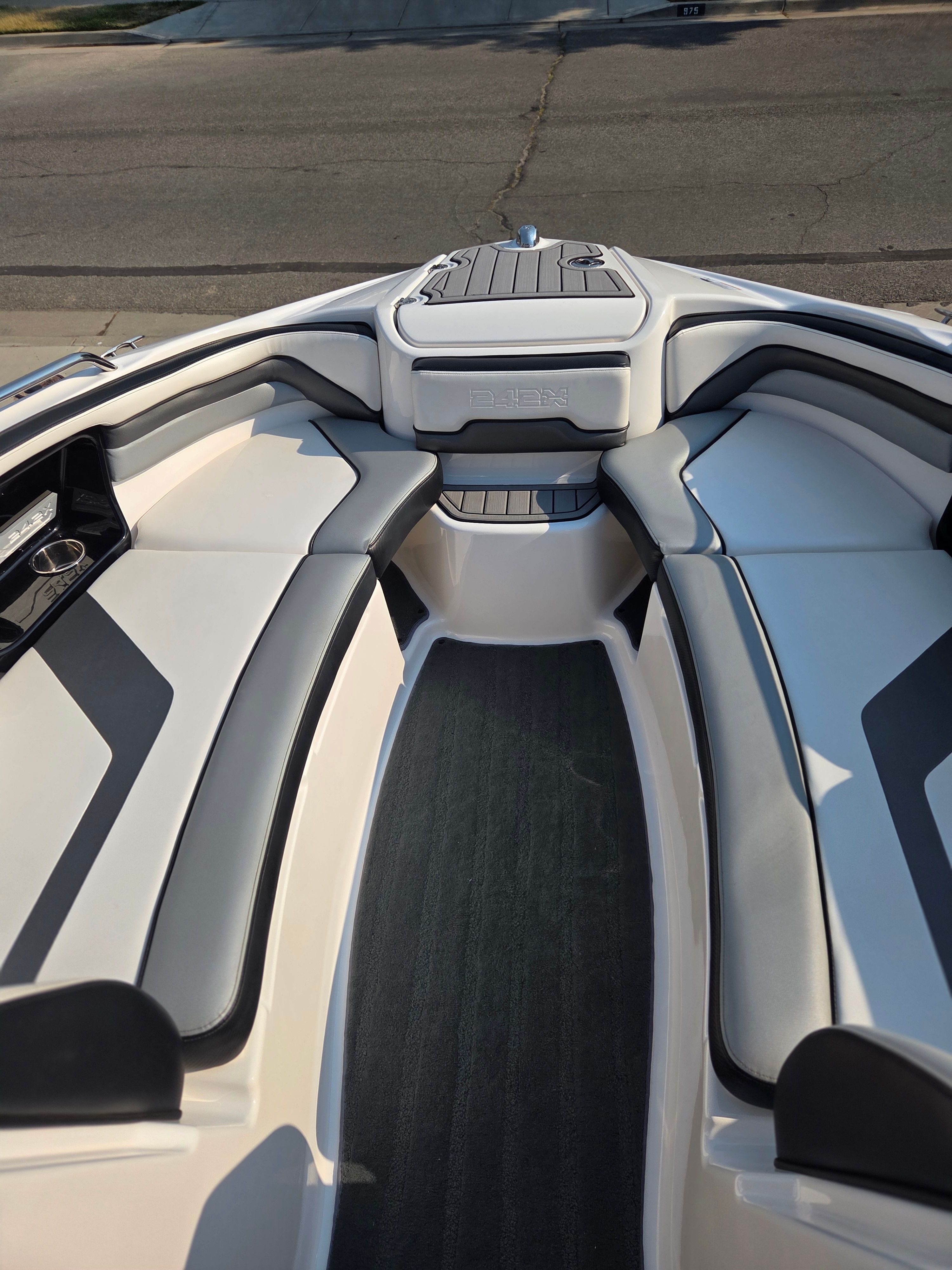 The image shows the bow area of a 2016 Yamaha 242X E-Series boat with cushioned seating.