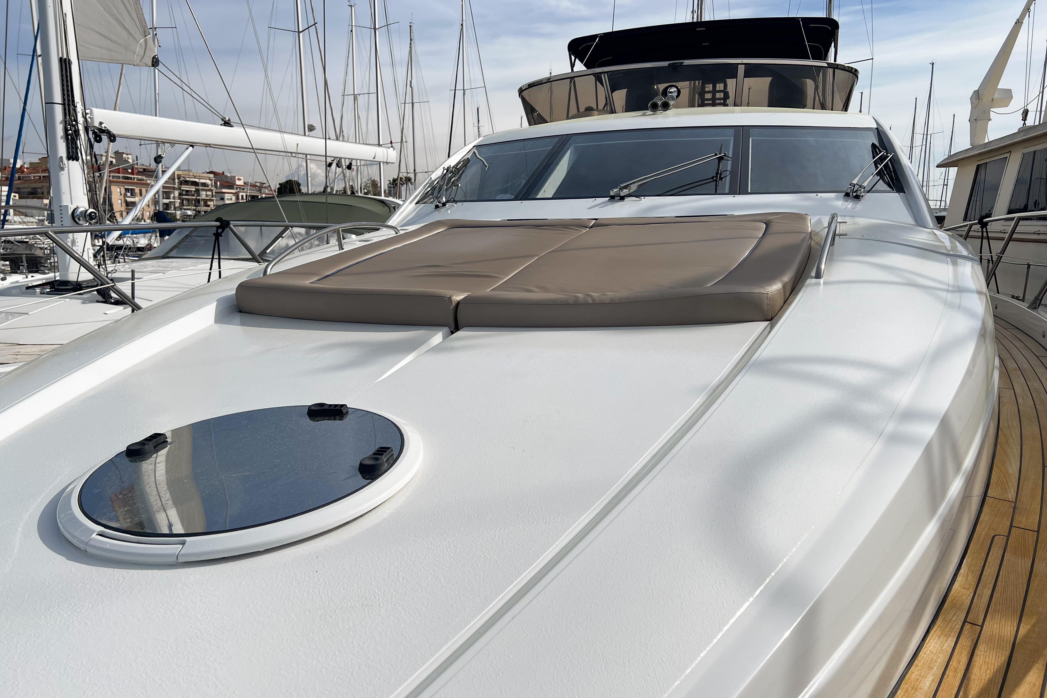 2007 Sunseeker Manhattan 66 yacht with sleek deck and sunbathing area in marina.