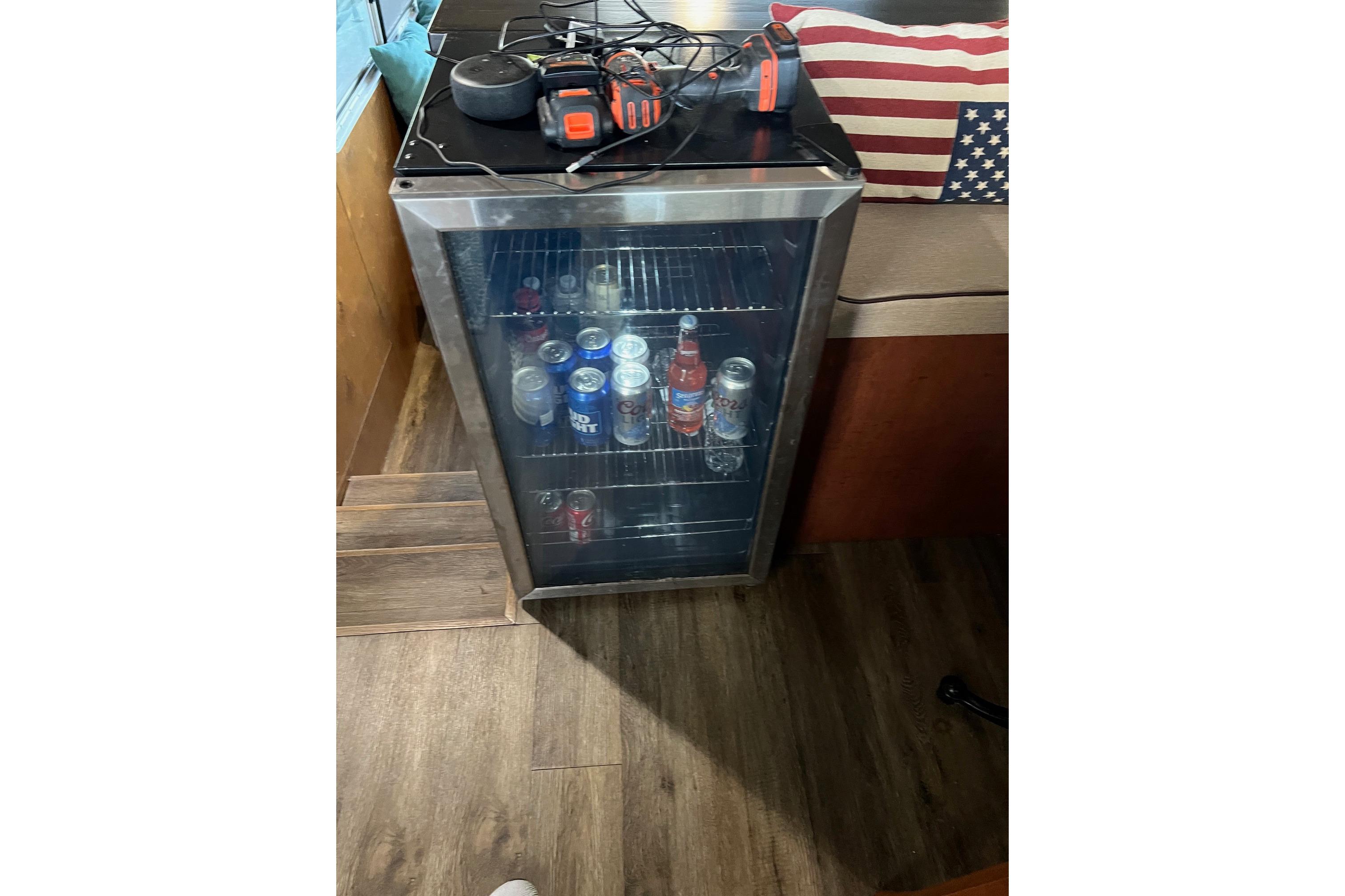 Mini fridge stocked with drinks inside a 1989 Holiday Mansion Super boat.