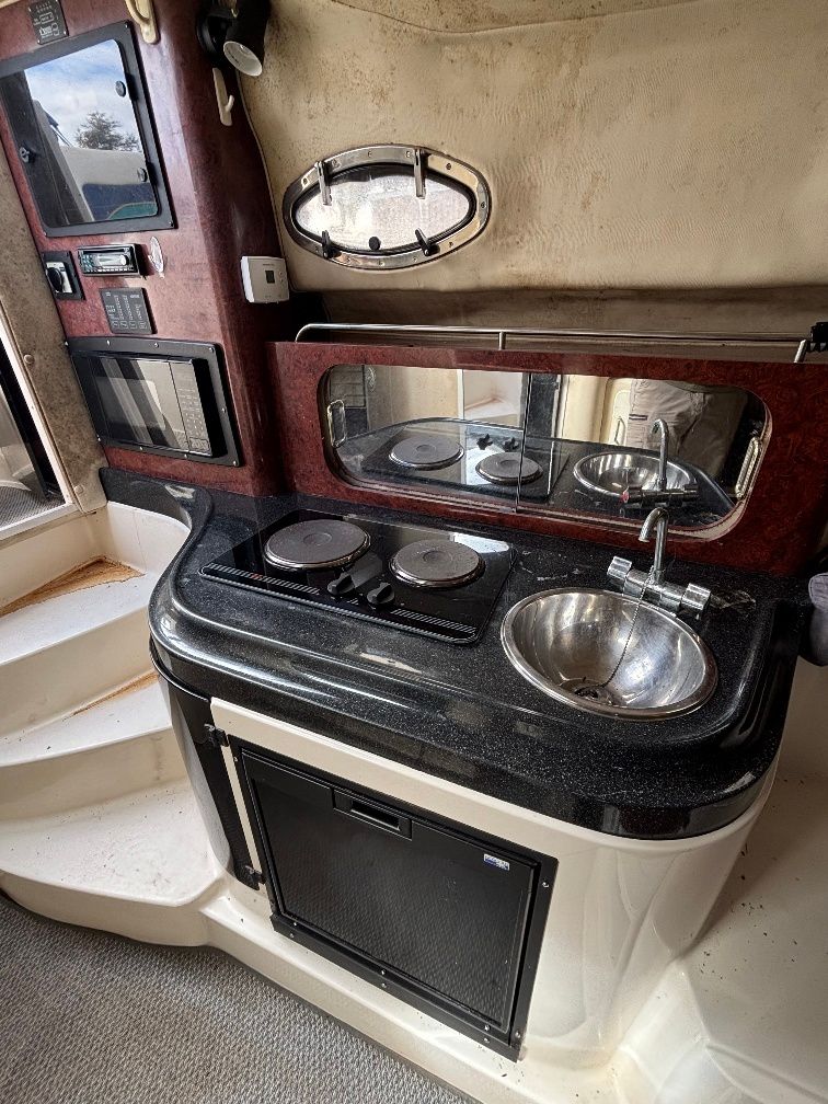 1997 Donzi 275LXC interior with kitchenette and sink.