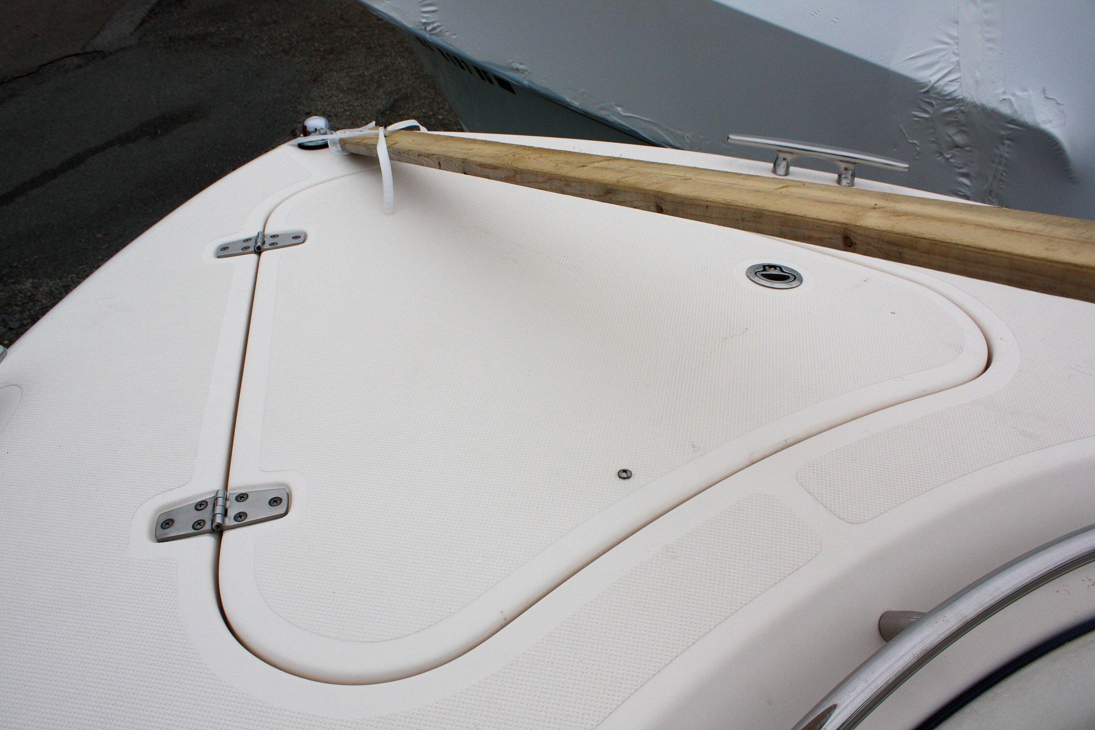 2013 Pursuit ST 310 Sport boat deck with wooden beam and cleat.