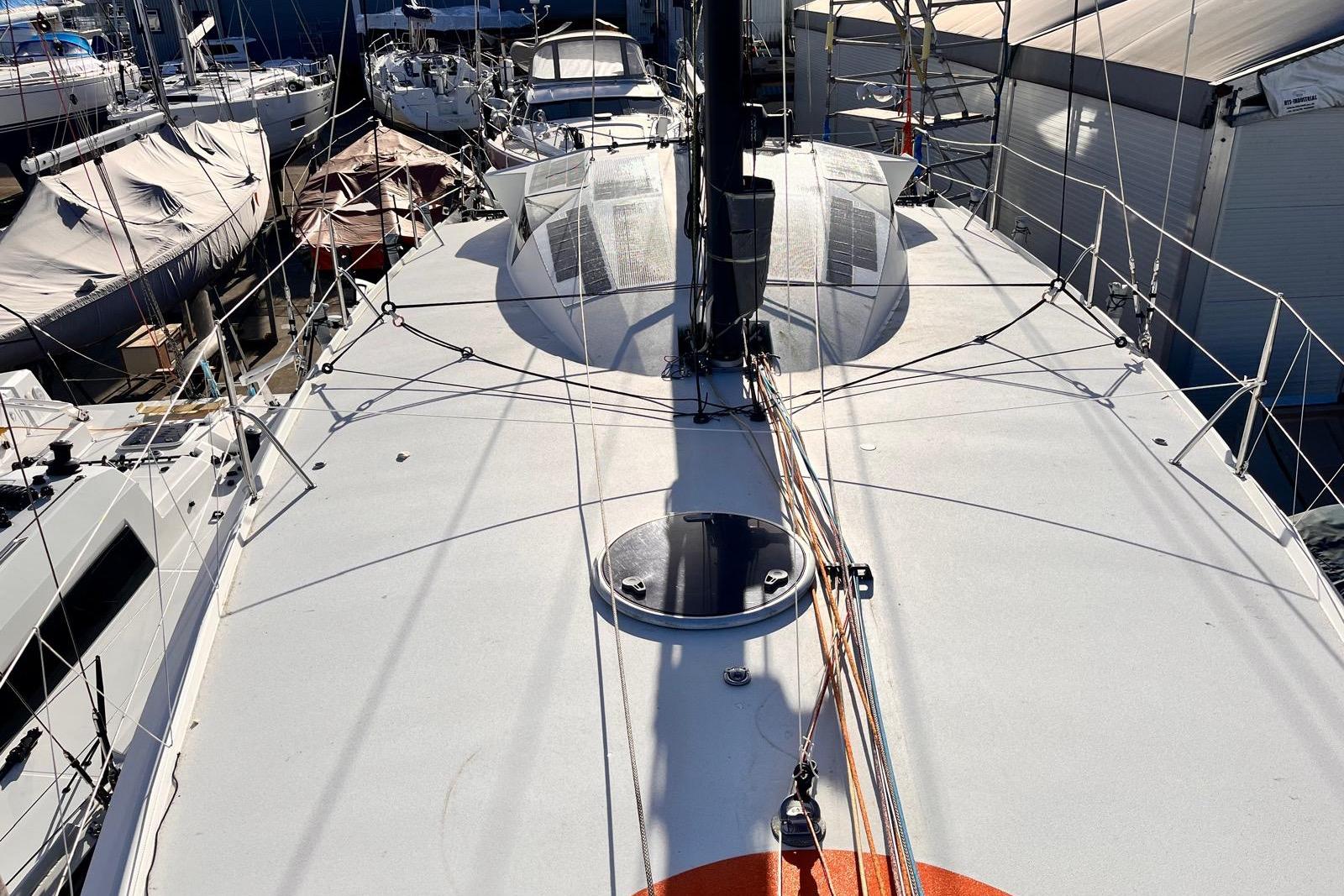 Sailboat deck of Class 40 Mach 40.3, 2015 model, in a marina setting.