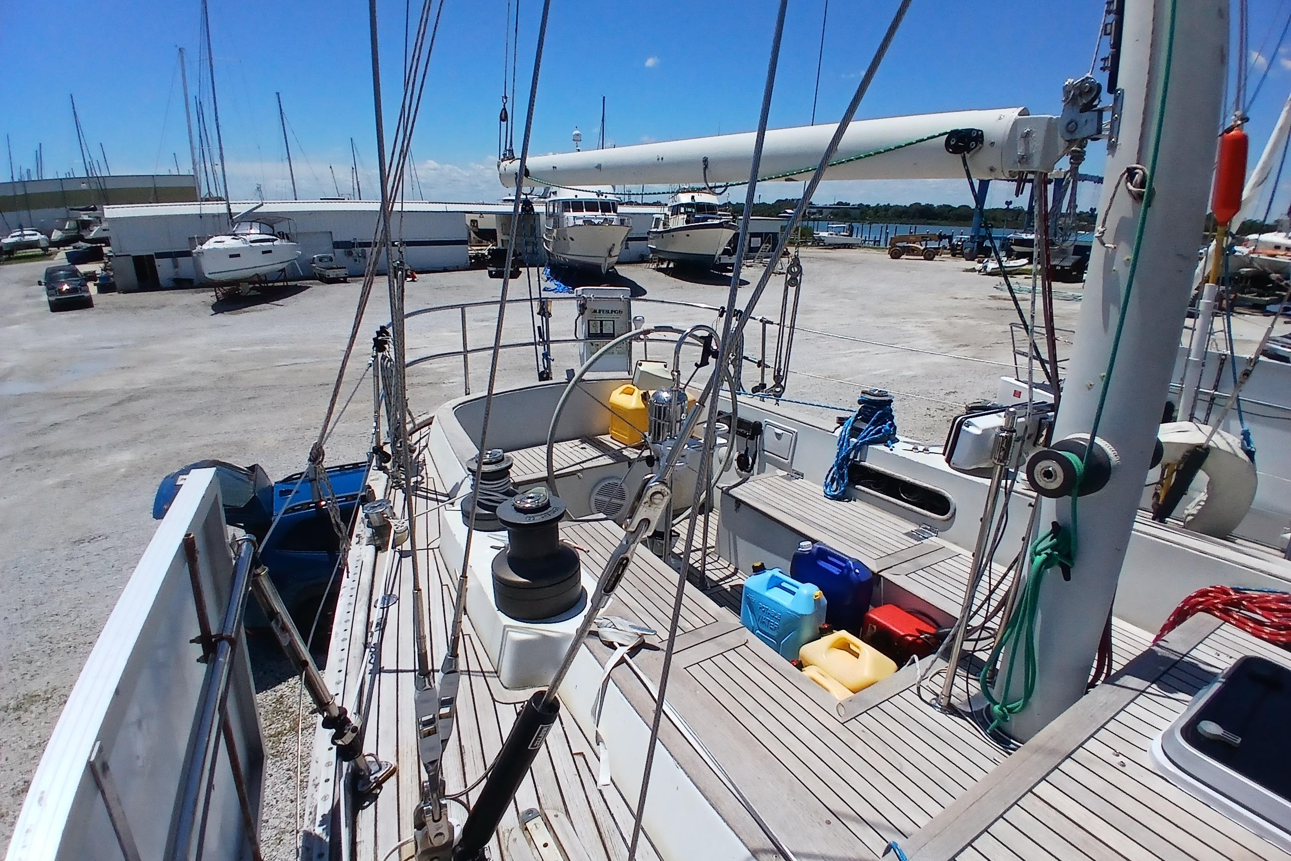 Sailboat Kaufman Skye 51, 1981 model, docked in a marina with clear blue skies.