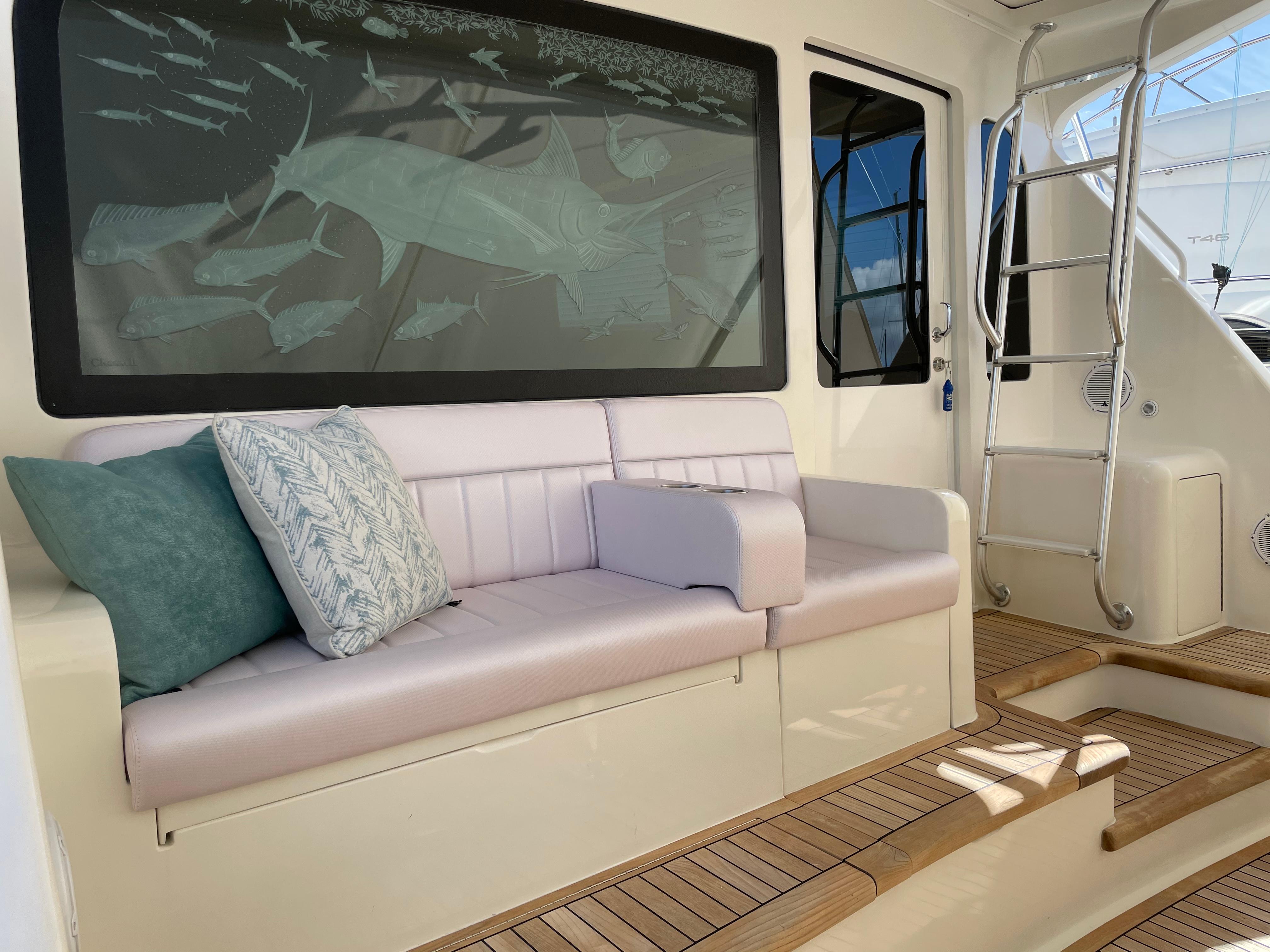 2007 Viking 52 Convertibles yacht interior with cushioned seating and decorative pillows.