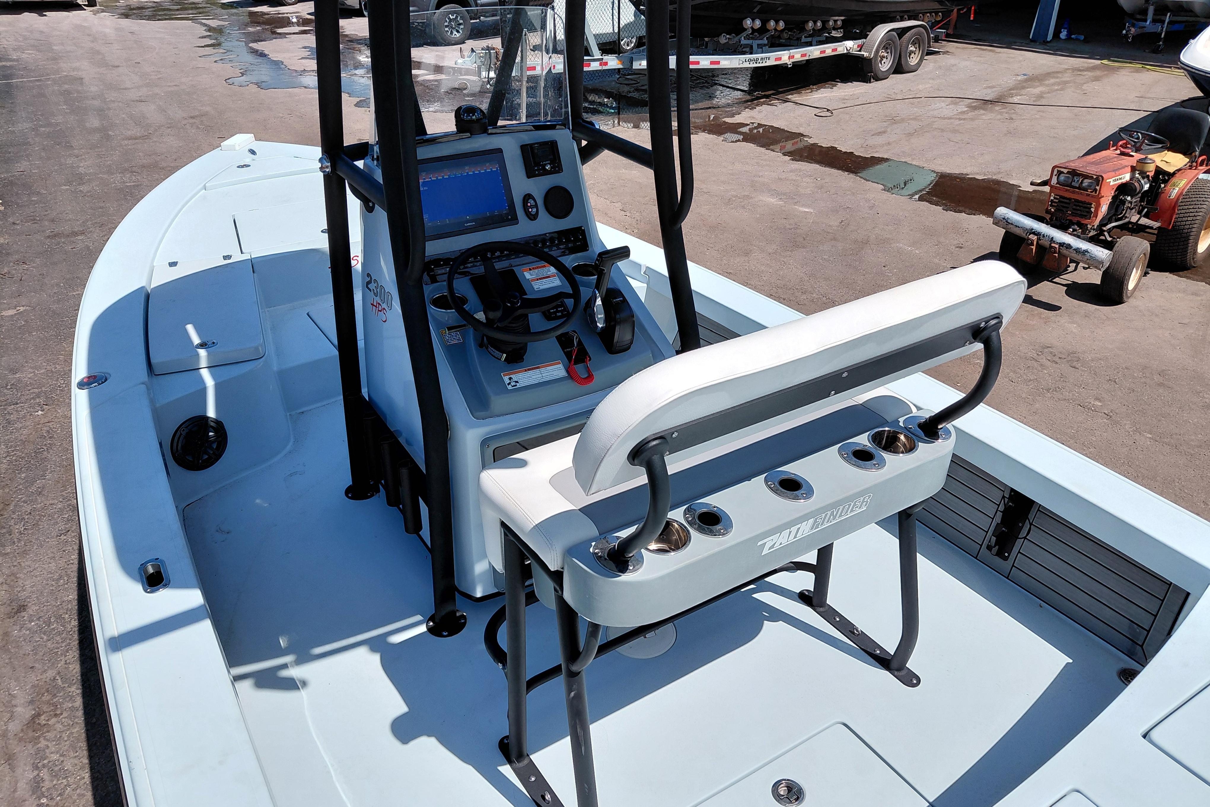2022 Pathfinder 2300 HPS boat interior with console and seating, parked outdoors.