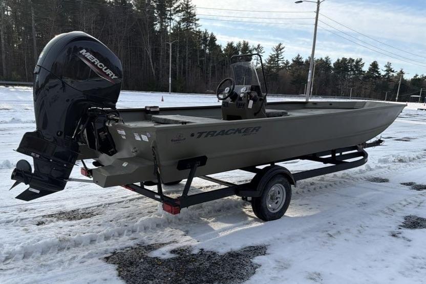 2026 Tracker Grizzly 2072 CC boat on trailer in snowy landscape.