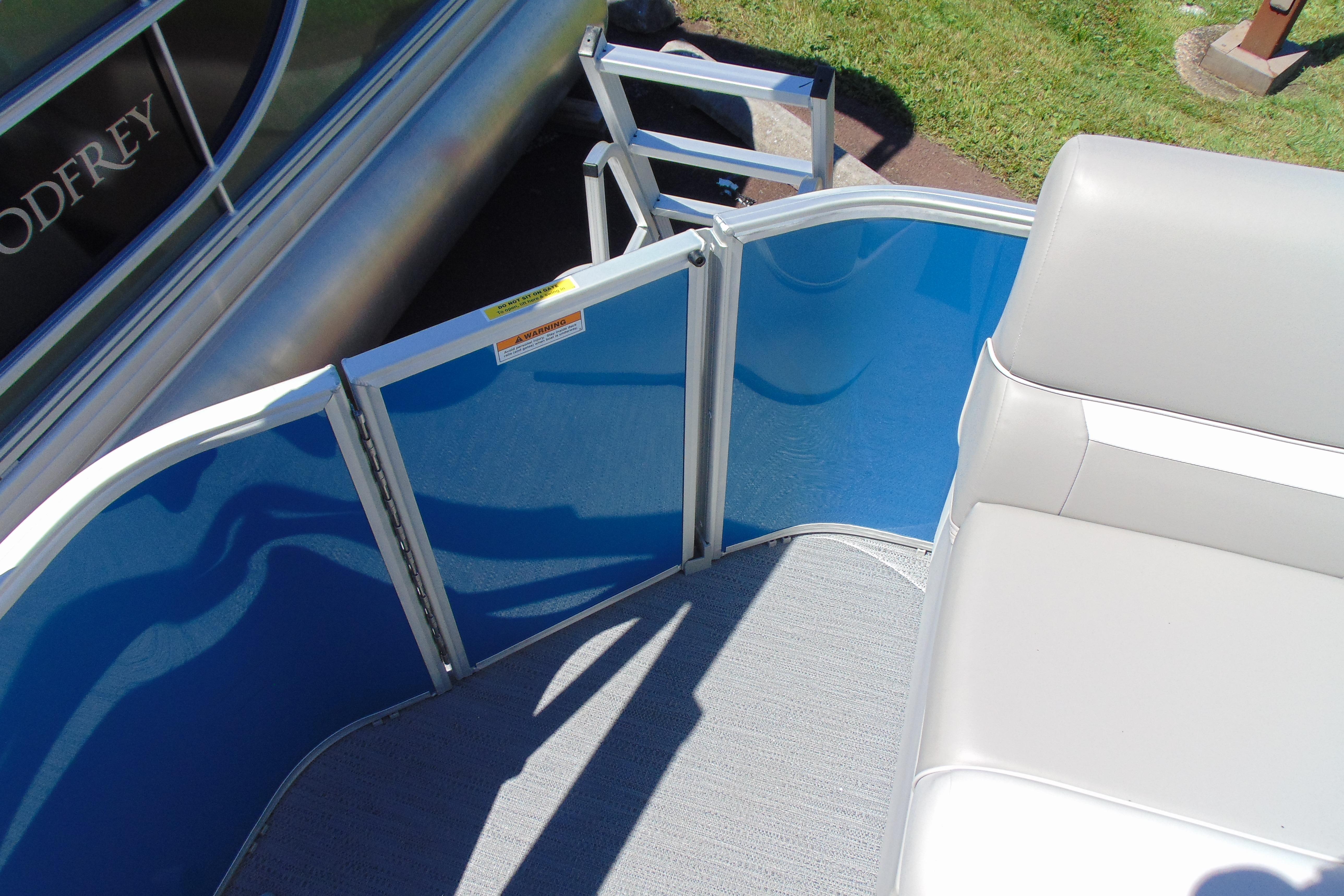 2026 Godfrey eX1680 CX pontoon boat interior with blue paneling and white seating.