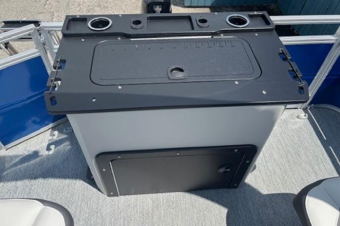 2026 Sun Tracker Fishin' Barge 20 DLX fishing station with cup holders and storage.