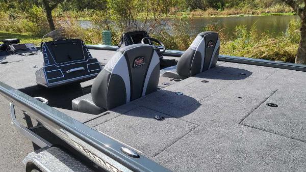 2025 Ranger ALPHA 208 boat interior with dual seats and control panel by a lake.