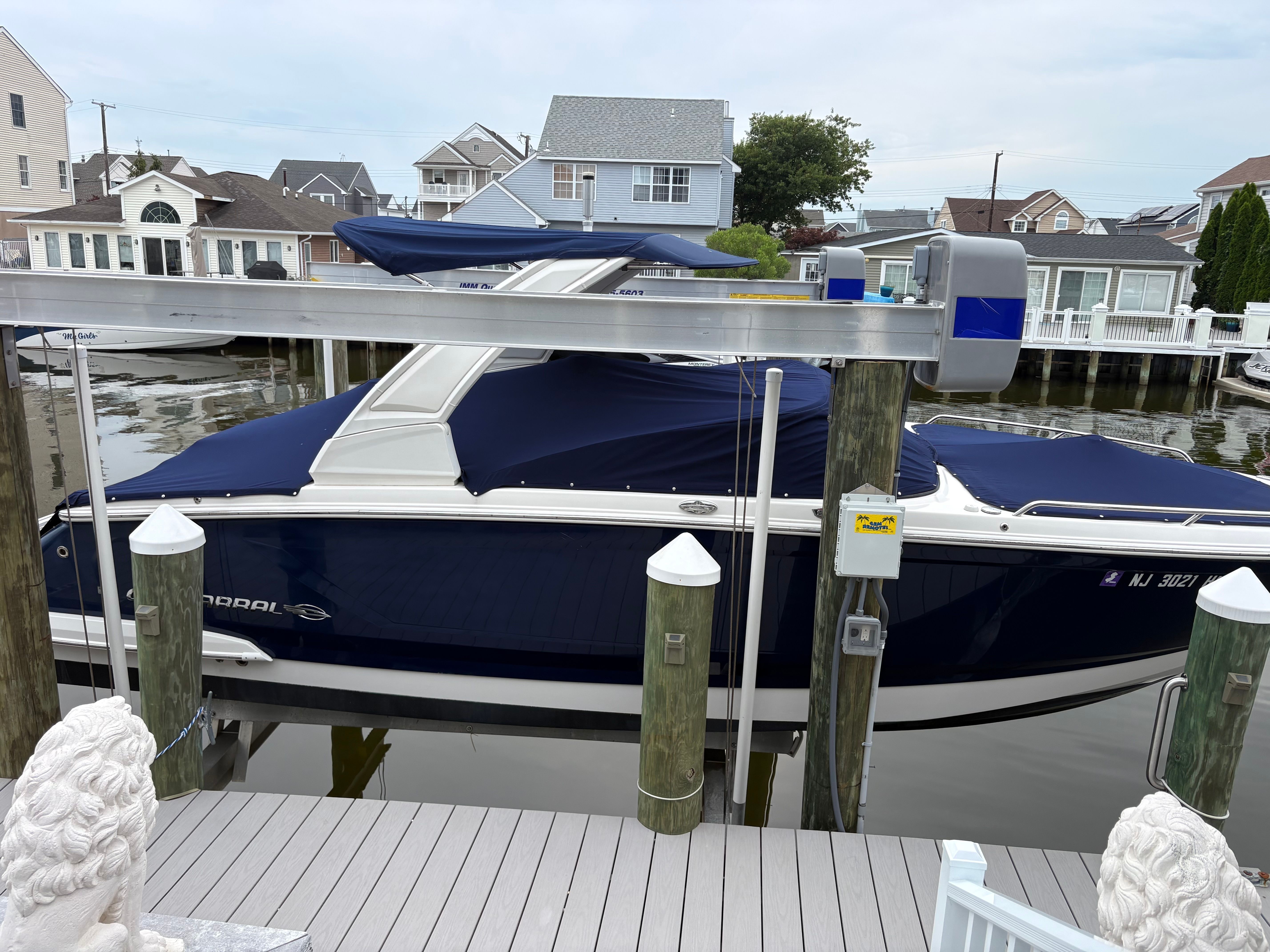 A 2019 Chaparral SSX277 boat docked in a residential area.