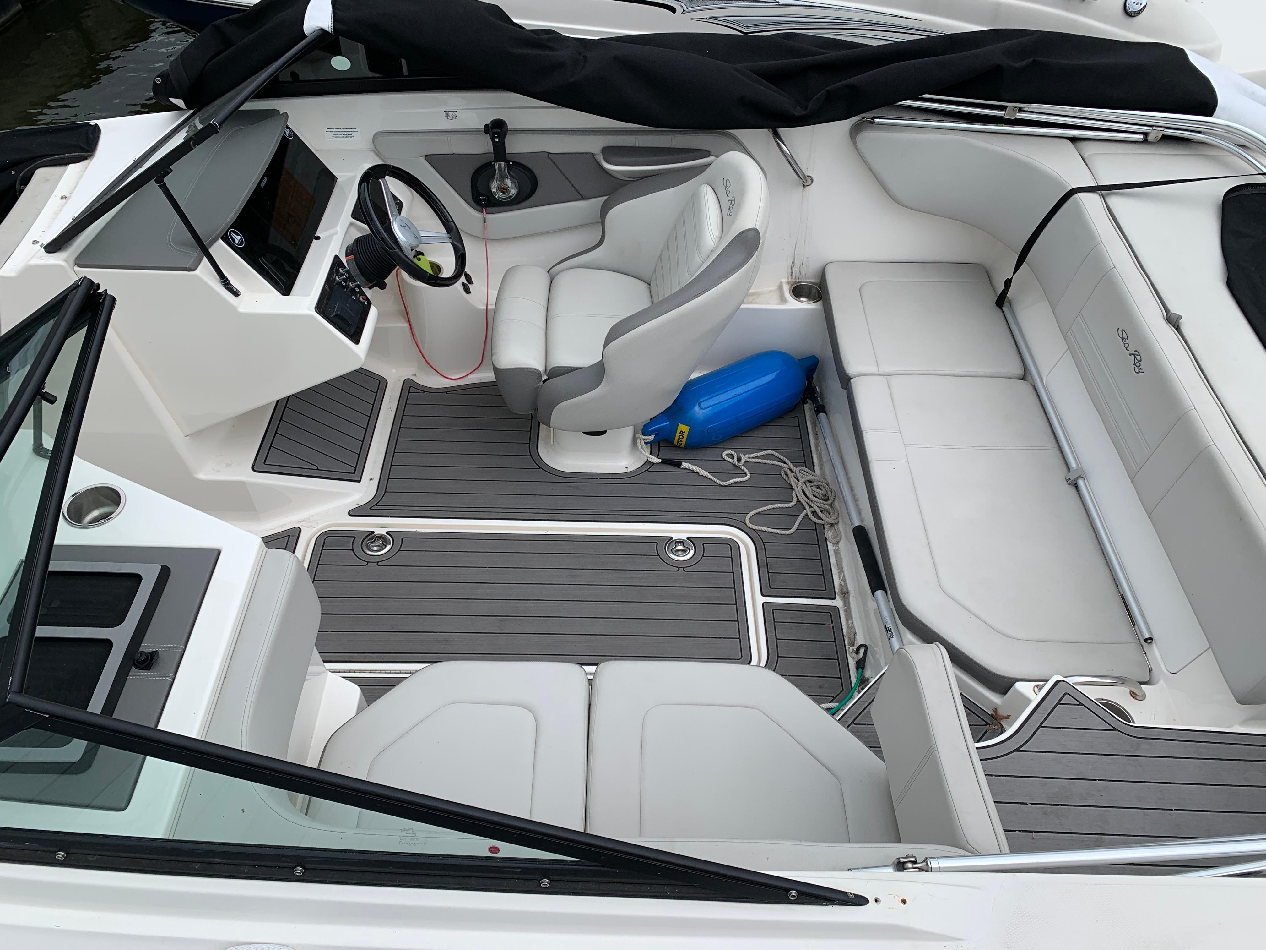 2020 Sea Ray SPX 190 Outboard boat interior with white seating and modern dashboard.