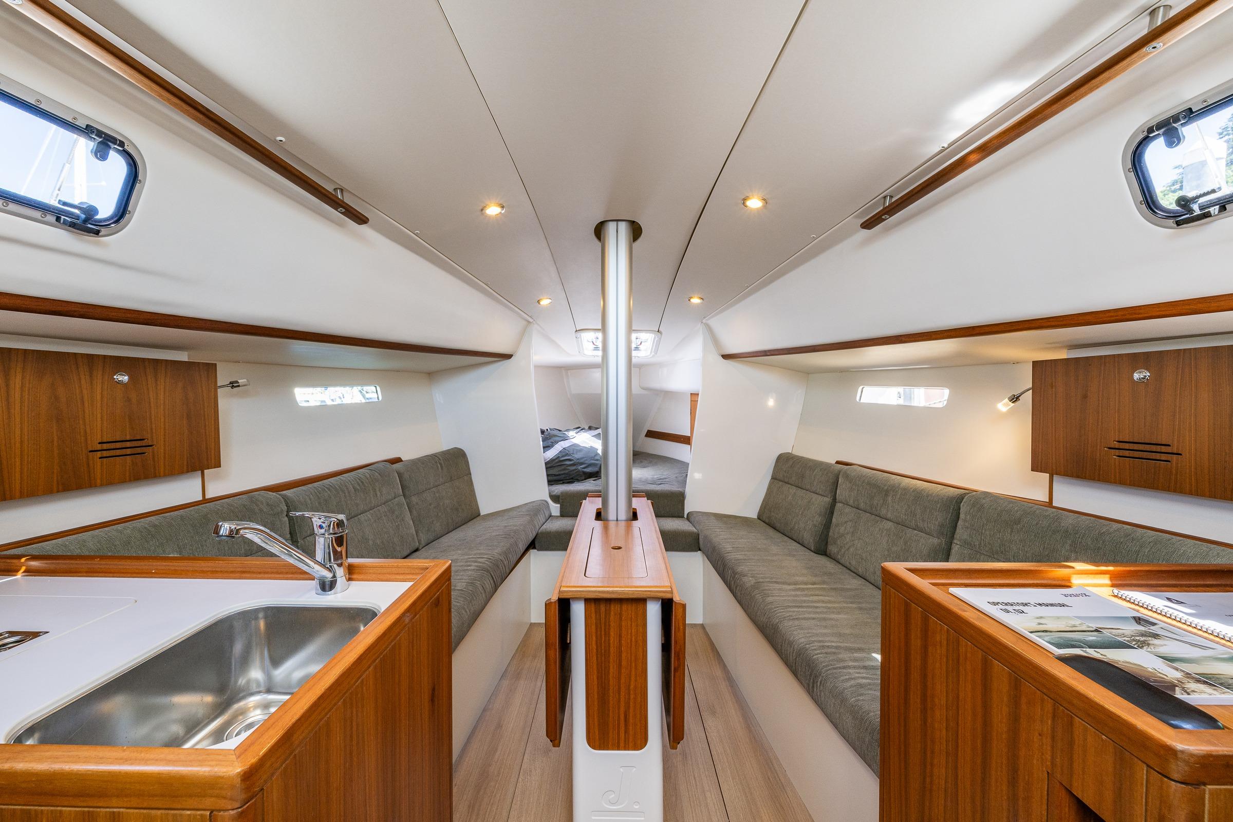 Interior of 2018 J Boats J/97E sailboat with modern wood finish and cozy seating.